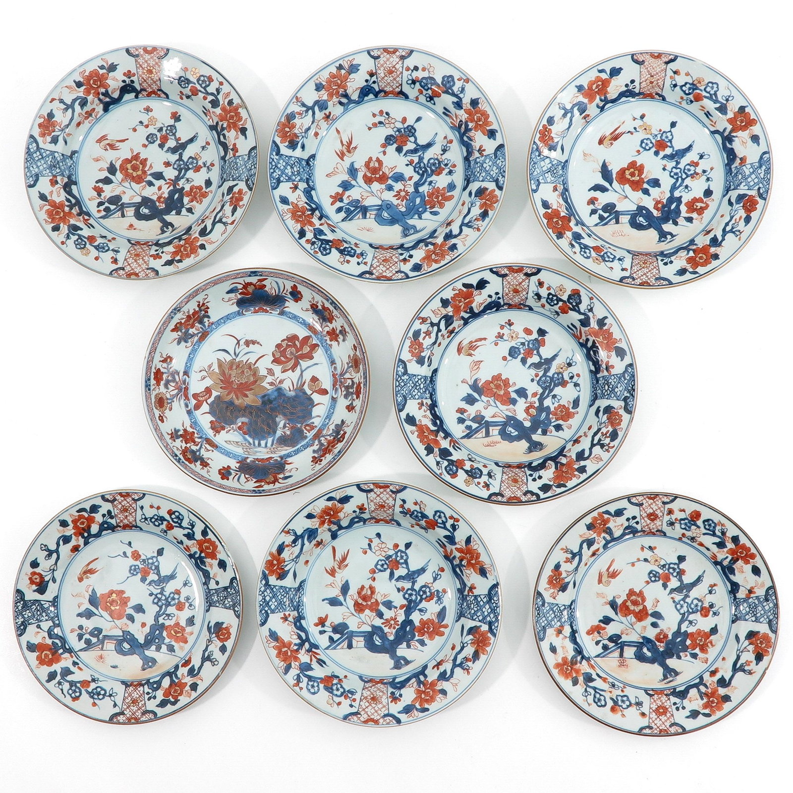 A Collection of 8 Imari Decor Plates: Depicting scene in garden in iron red, blue and gilt decor, 18th Century, 23 cm. in diameter.