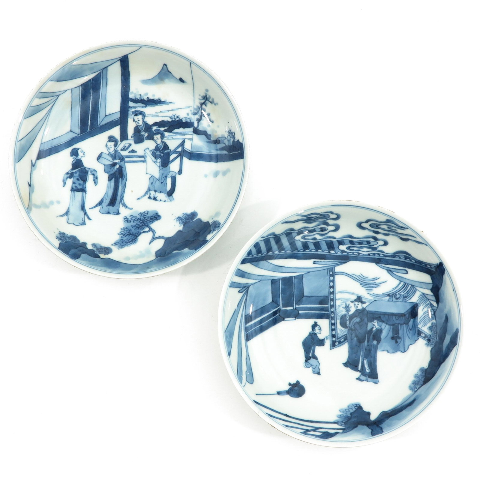 A Pair of Blue and White Plates: Depicting Chinese figures, 19 cm. in diameter.