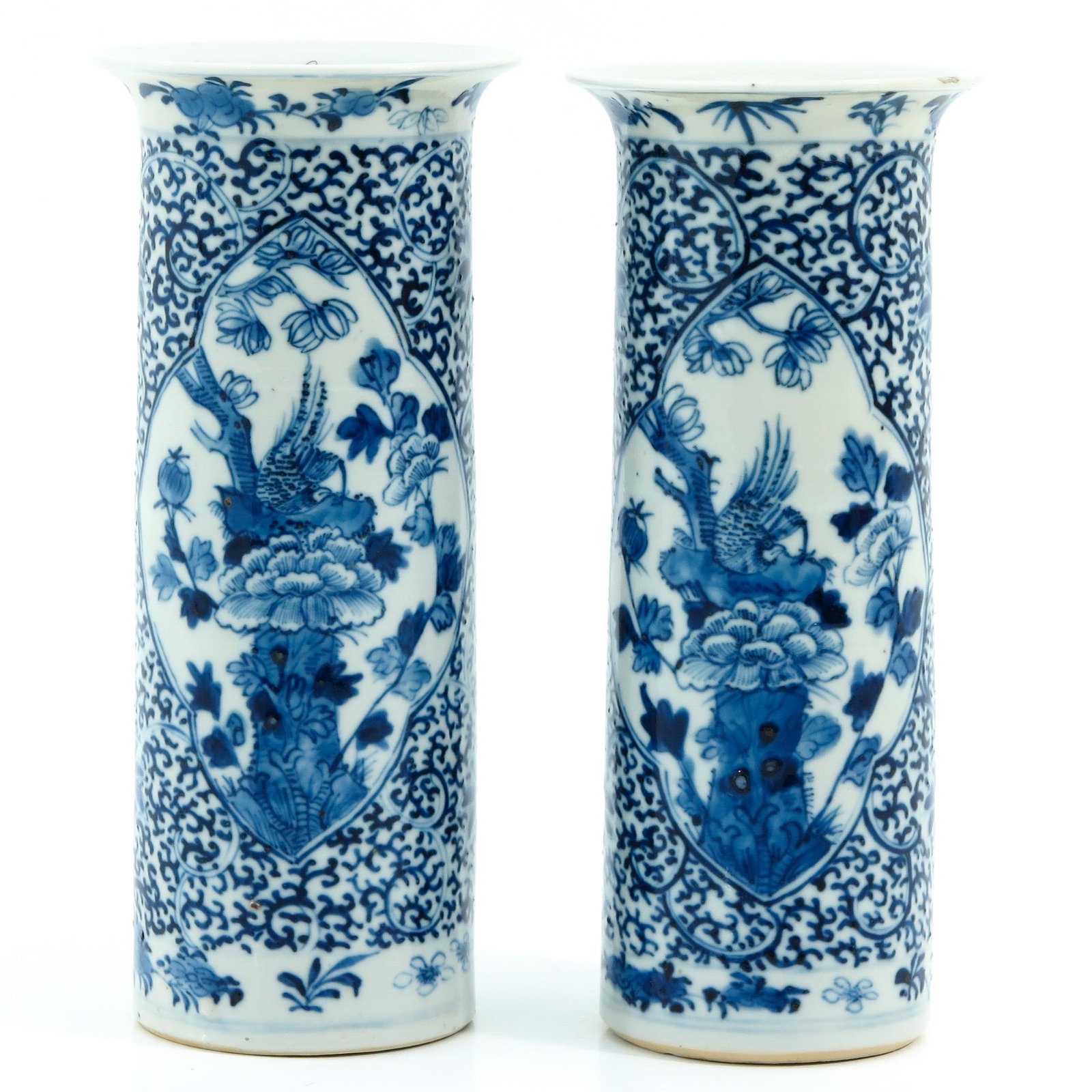 A Pair of Blue and White Vases: Floral decor, 21 cm. tall, chip.