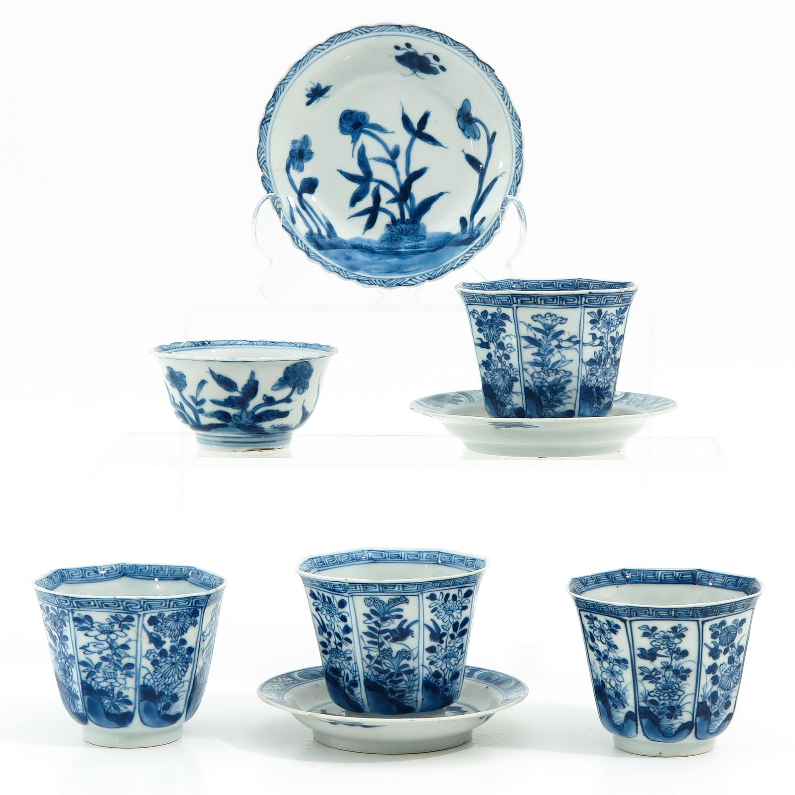 A Collection of Cups and Saucers: In diverse blue and white decors, including 5 cups and 3 saucers, largest saucer is 12 cm. in diameter chip and hairline.