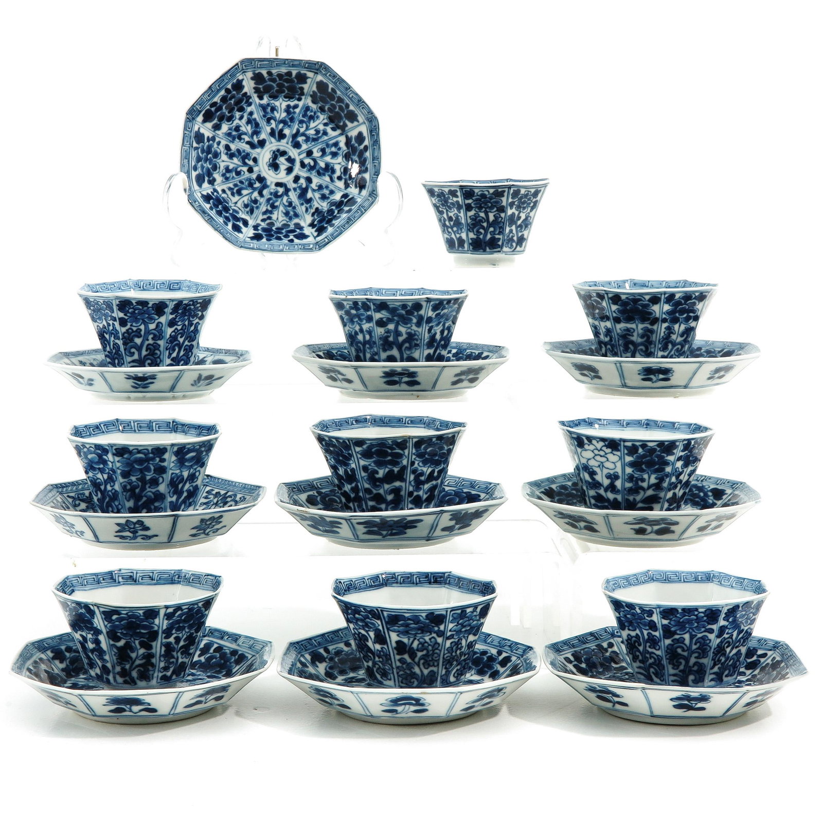 A Collection of Cups and Saucers: Blue and white floral decor, saucers are 10 cm. in diameter.