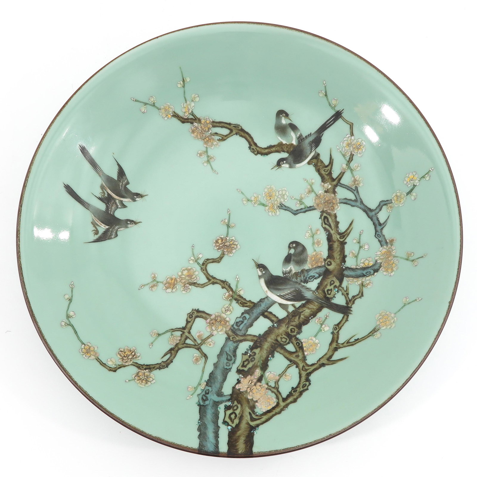 A Celadon Charger: Decorated with birds in tree with flower blossoms, 53 cm. in diameter.