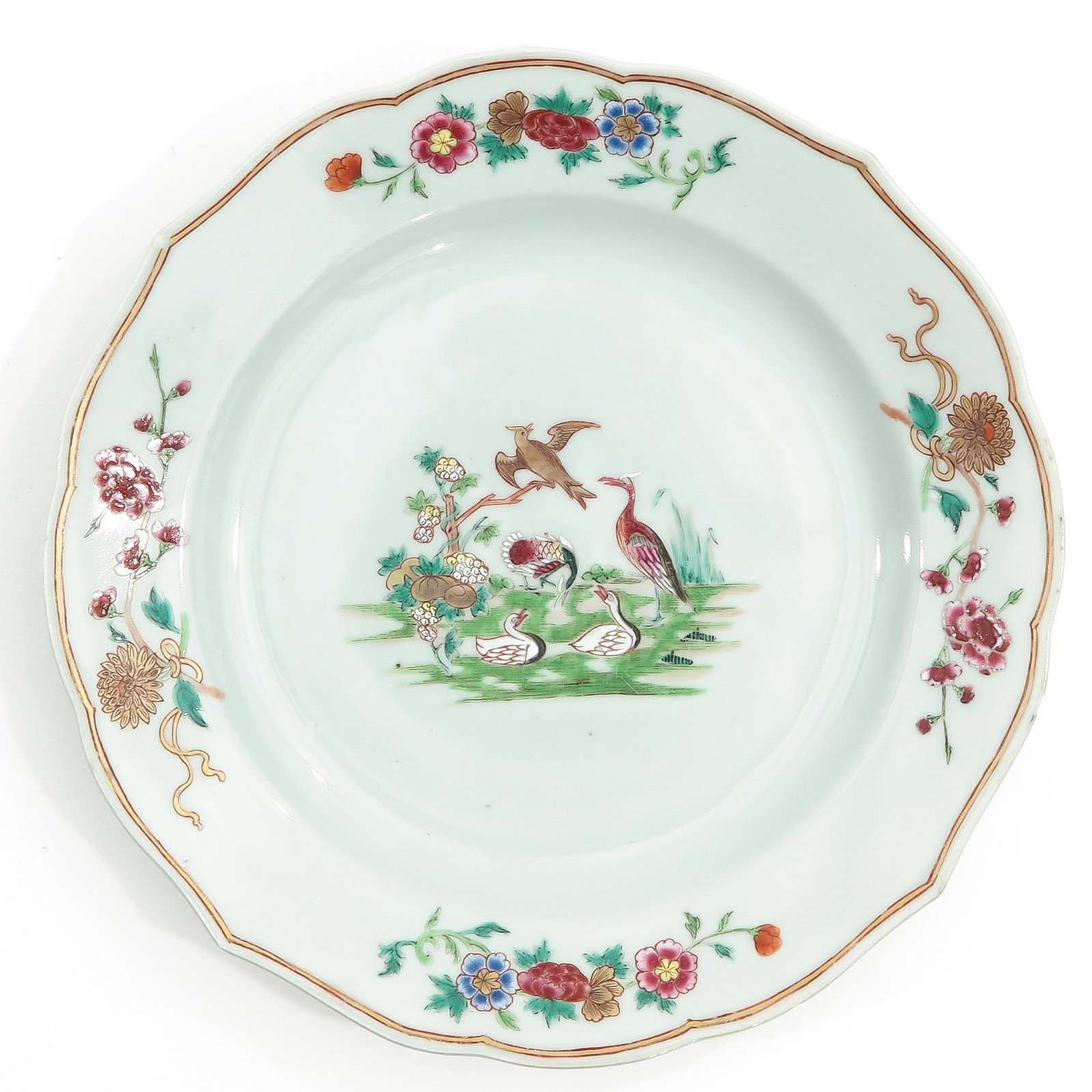 A Famille Rose Plate: Depicting birds in garden in Famille Rose enamels, circa 1800, 25 cm. in diameter.