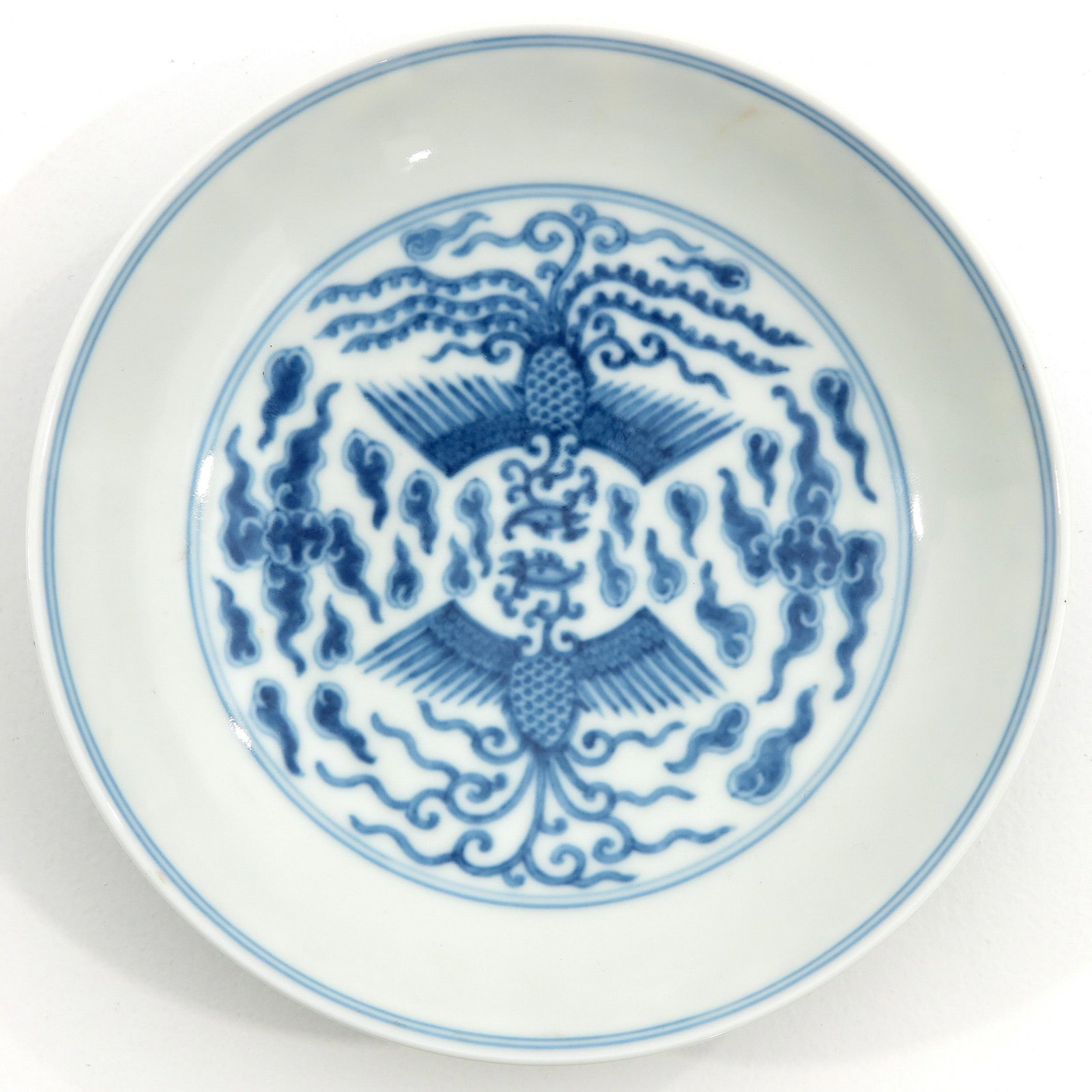 A Blue and White Dish: Decorated with bird of paradise, Guangxu mark, 16 cm. in diameter.