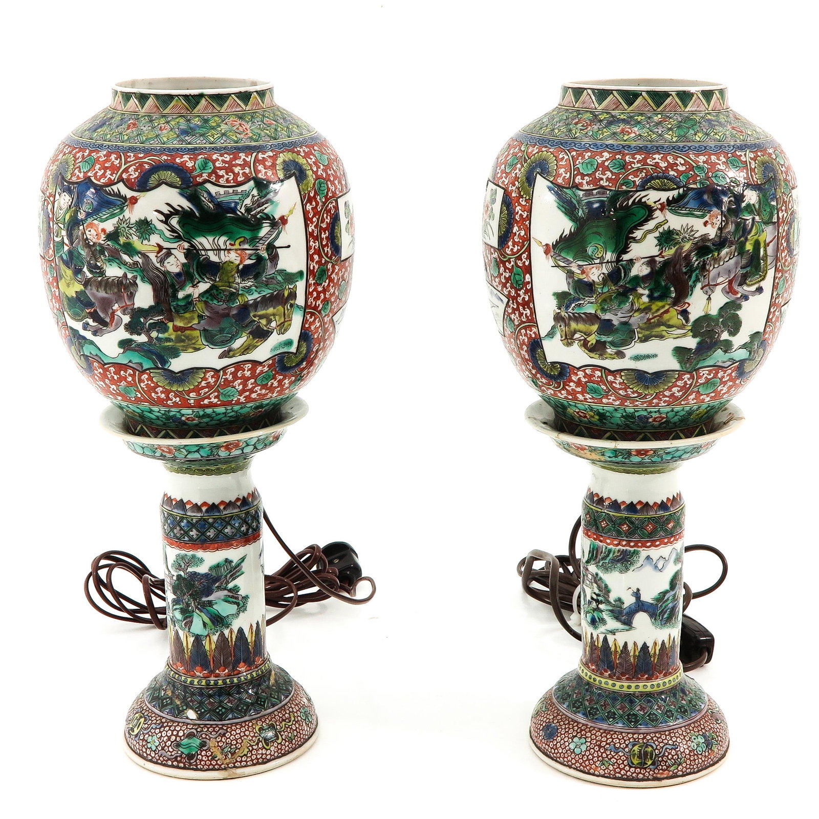 A Pair of Famille Verte Lamps: Depicting Chinese warriors, 43 cm. tall, restored.