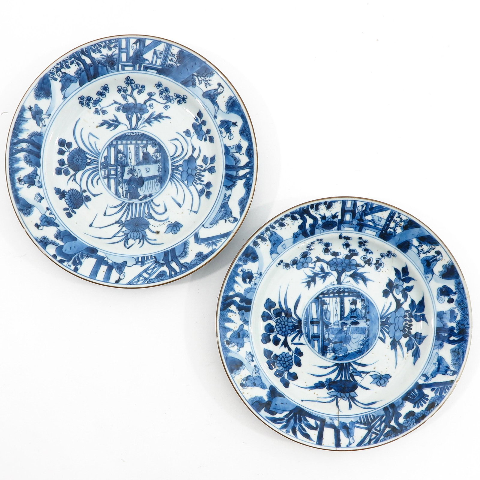 A Pair of Blue and White Plates: Decorated with Chinese figures and flowers, Kangxi Period, 23 cm. in diameter, restored.