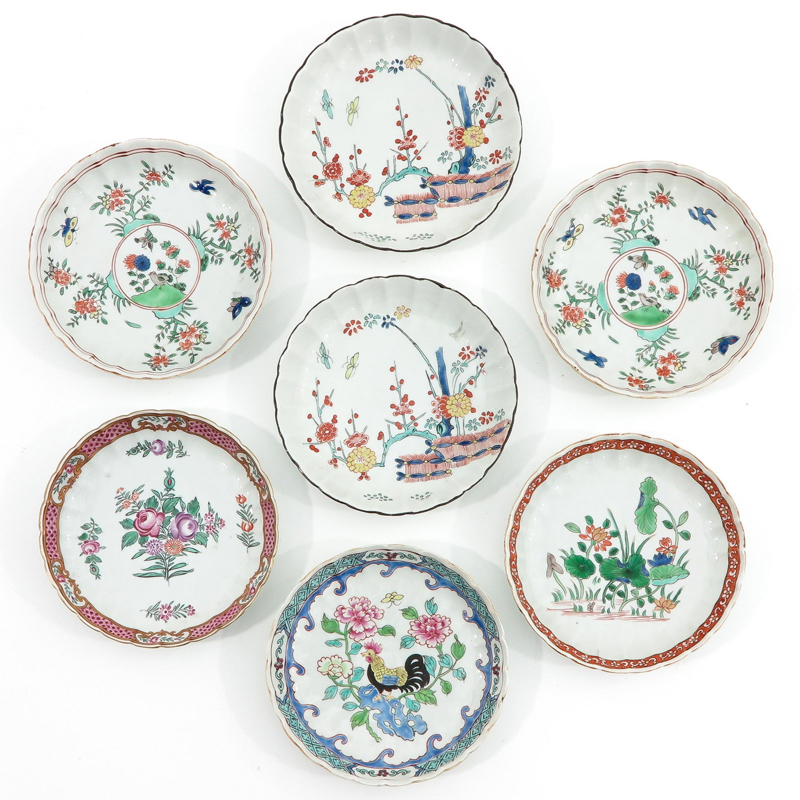 A Lot of 7 Small Plates: Decorated with flowers and butterflies, 14 cm. in diameter,