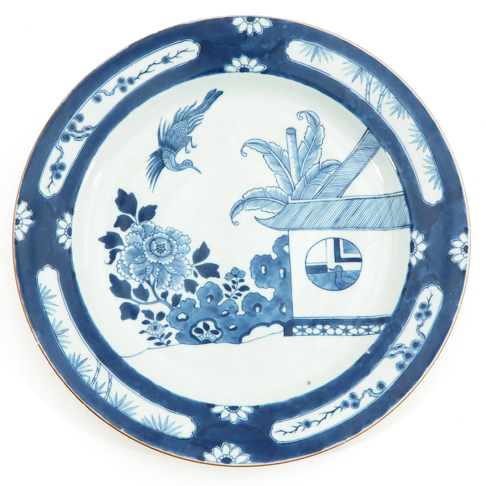 A Blue and White Charger: Depicting scene in garden with floral and bamboo decor border, circa 1800, 38 cm. in diameter, light fritting.
