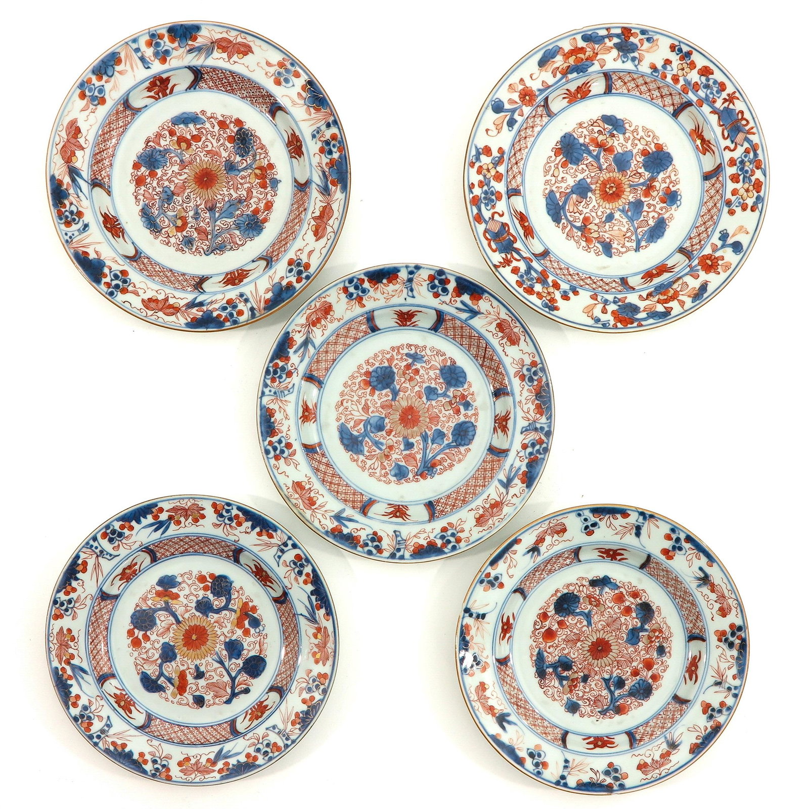 A Series of 5 Imari Plates: Floral decor in red, blue and gilt enamels, 23 cm. in diameter, chip and hairline.