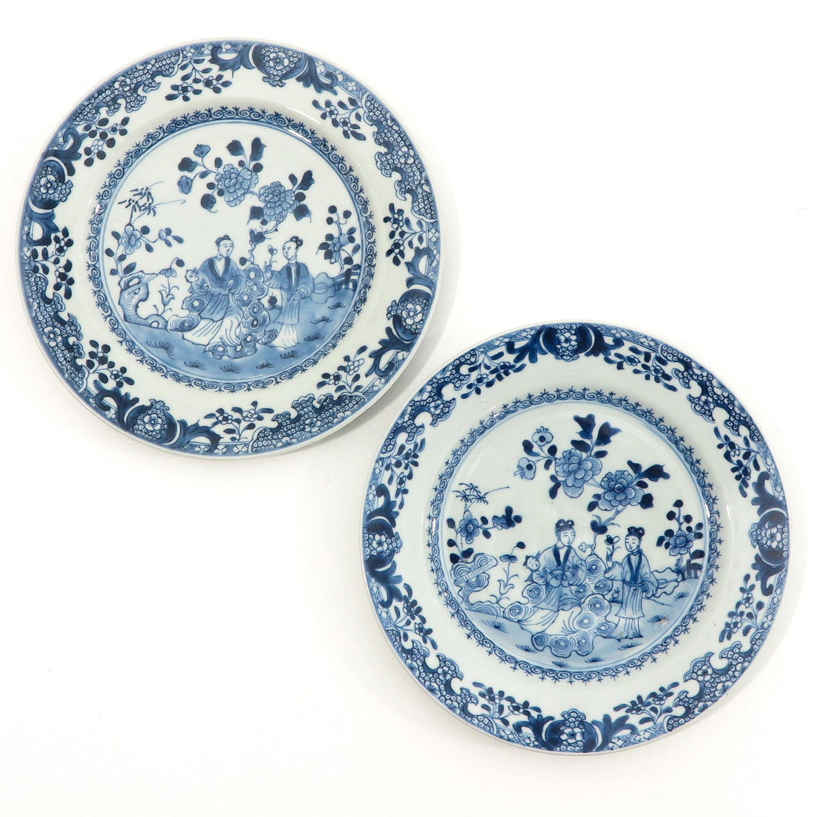 A Pair of Blue and White Plates: Depicting gathering of Chinese figures in garden, 23 cm. in diameter.