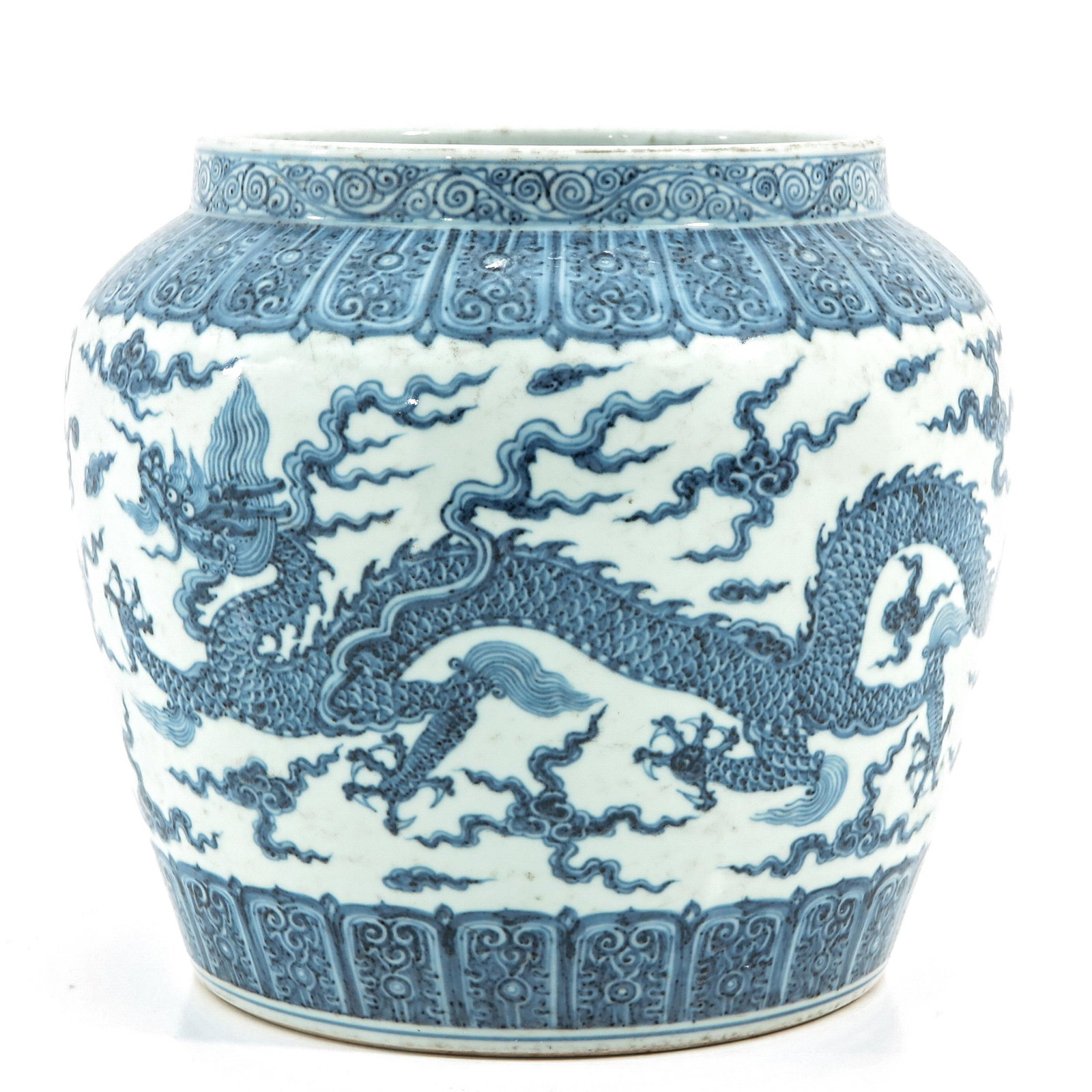 A Blue and White Jar: Decorated with Dragons and clouds, Wanli mark accross rim of jar, 25 cm. tall.