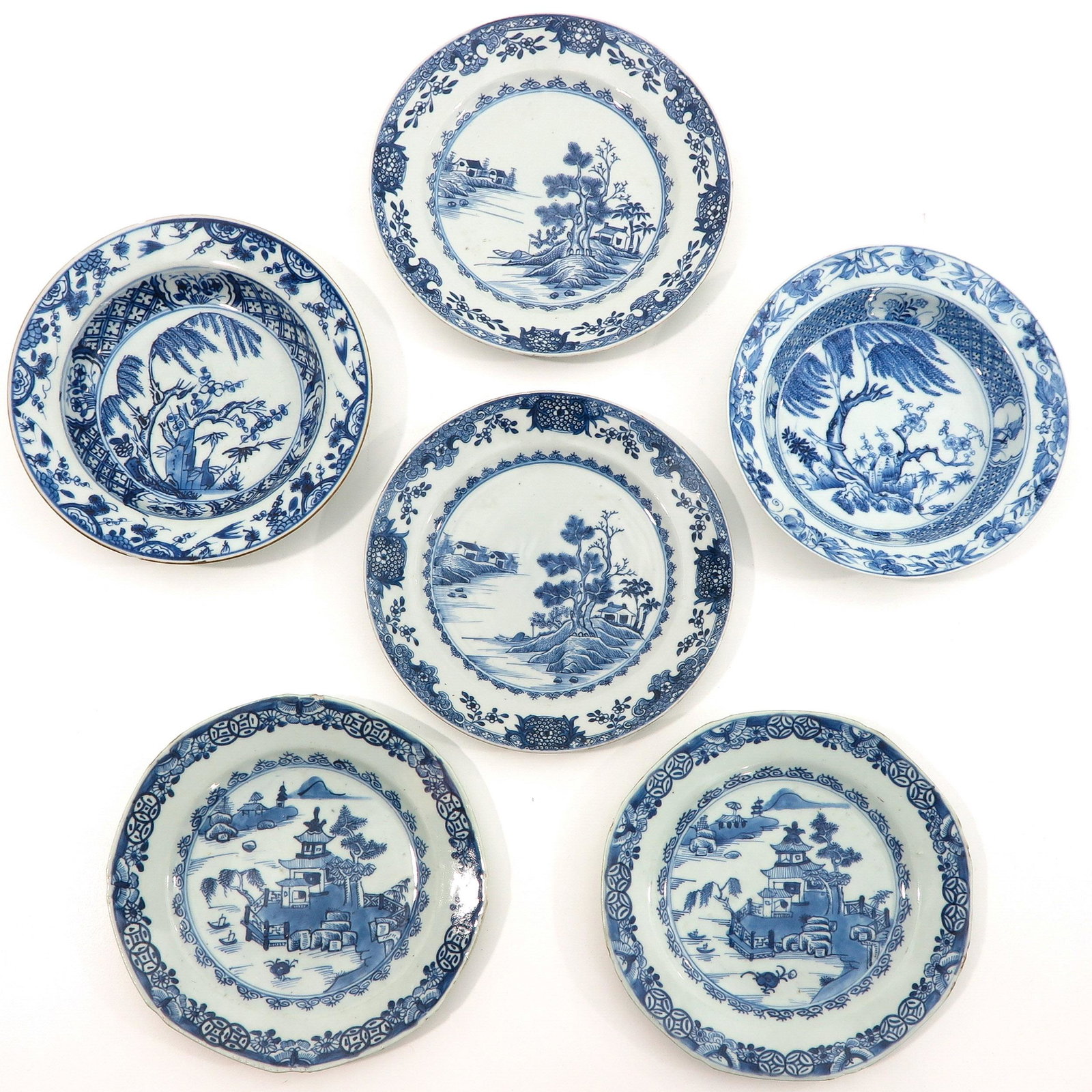 A Collection of 6 Blue and White Plates: In diverse decors, 18th Century, 23 cm. in diameter, chip and hairline.