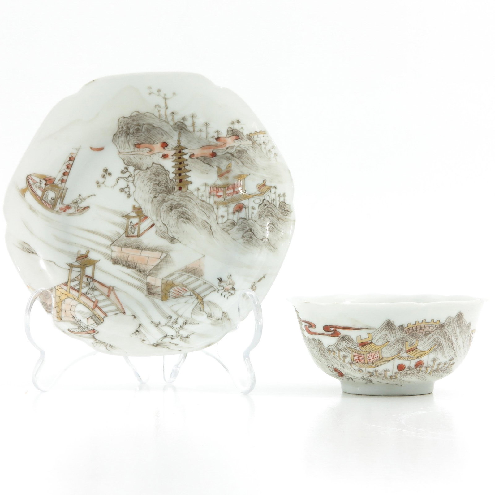 A Cup and Saucer: Milk and blood decor, 18th Century, depicting landscape, saucer is 13 cm. in diameter, hairline.