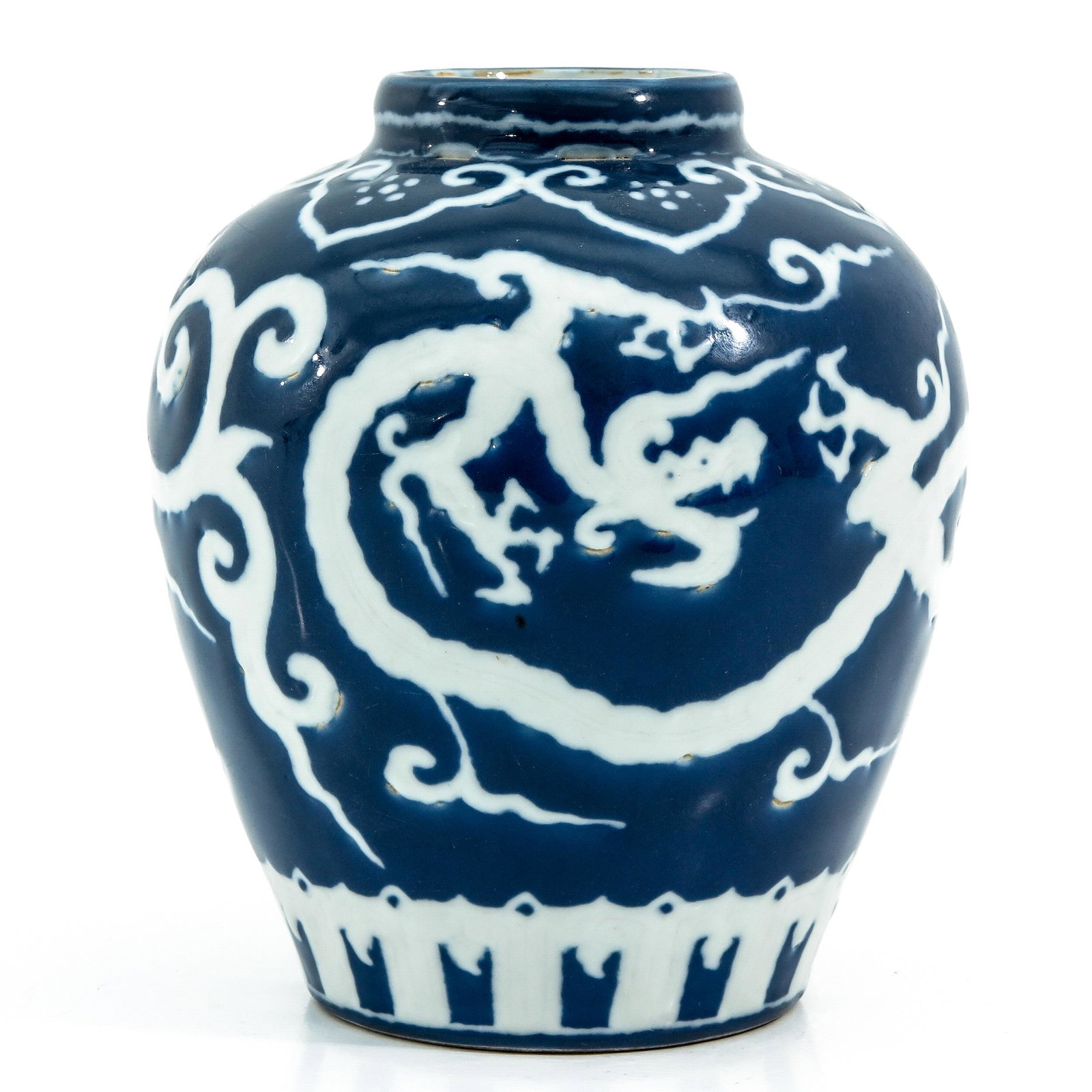 A Blue and White Vase: Dark blue ground with dragon decor, Xuande mark, 18 cm. tall.