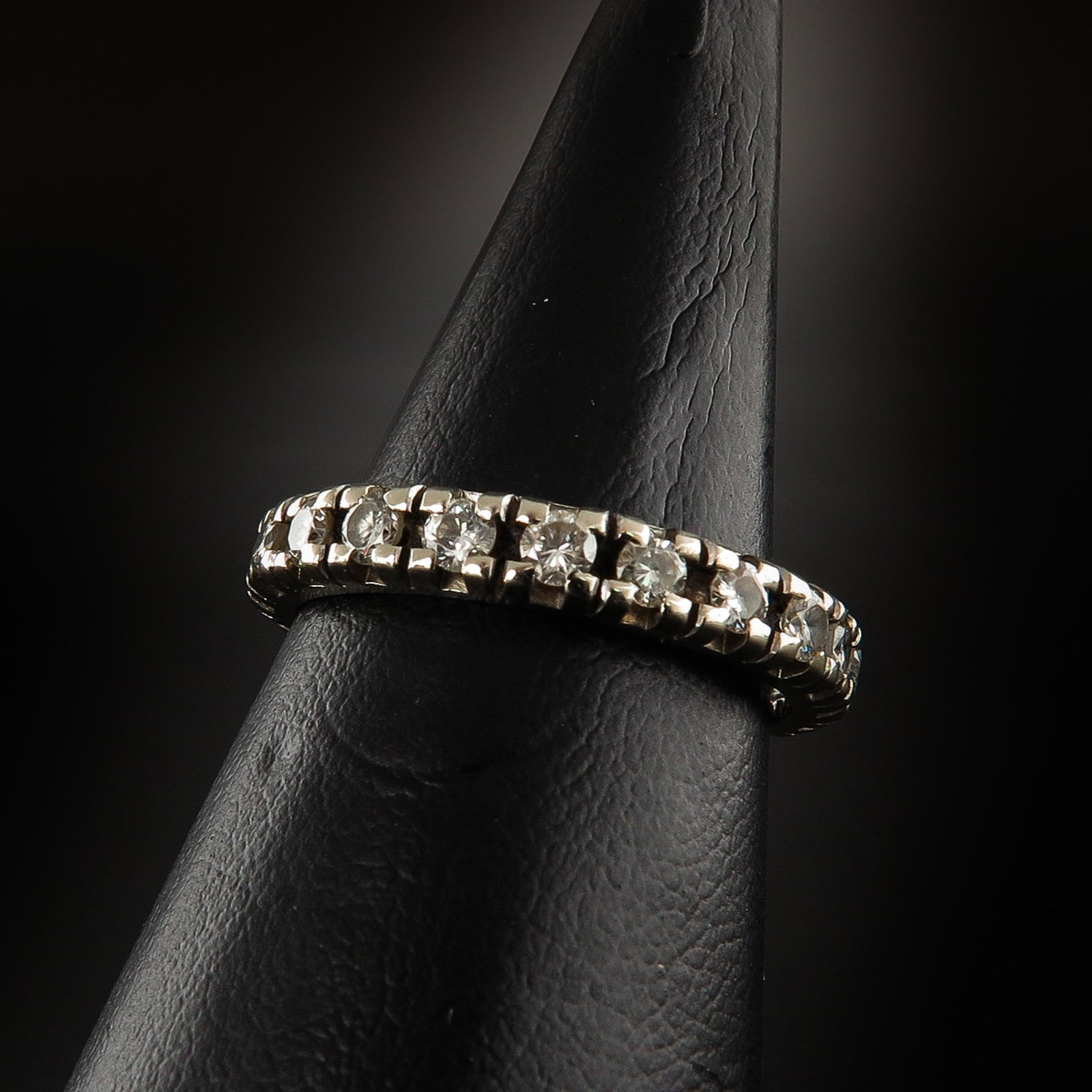 A Ladies Diamond Eternity Band: Set with 21 brilliant cut diamonds, ring size 17.