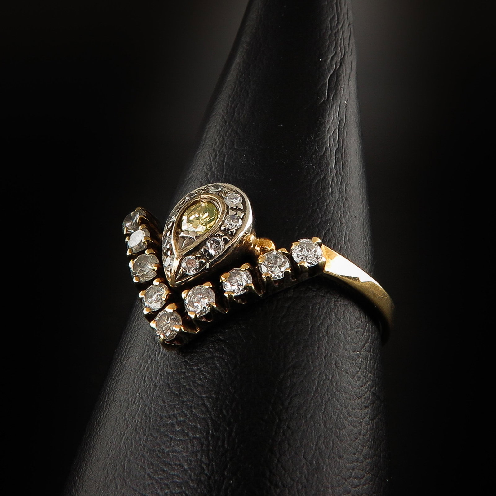 A Ladies Diamond Ring: Set with 19 diamonds, including 1 yellow diamond, ring size 20.