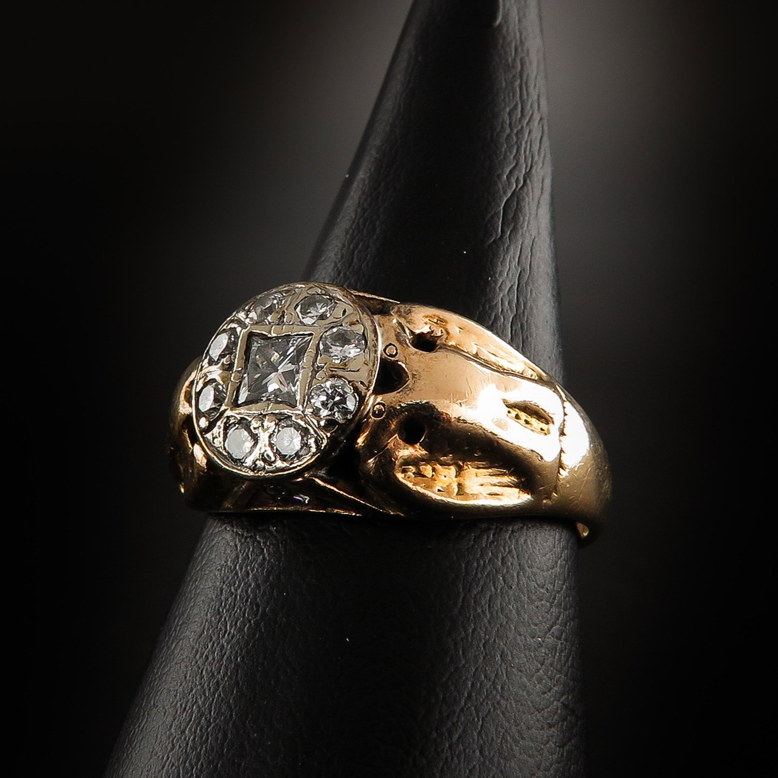 A Ladies Diamond Ring: Set with 10 brilliant cut diamonds and 1 princess cut diamond, ring size is 18.5.