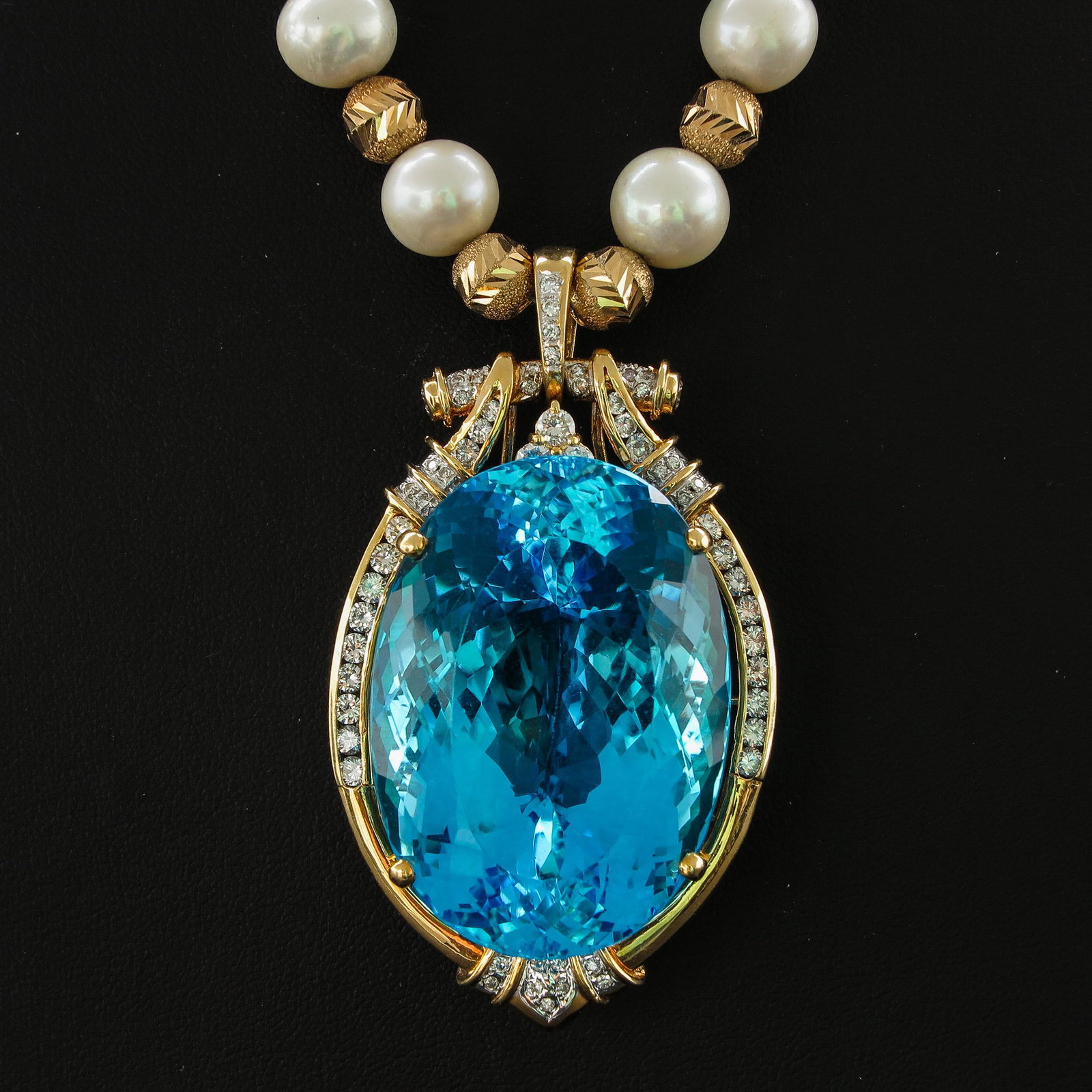A Pearl Necklace with Diamond Pendant: Including pendant 65 mm. long, 18KG, set with diamonds and faceted blue stones.