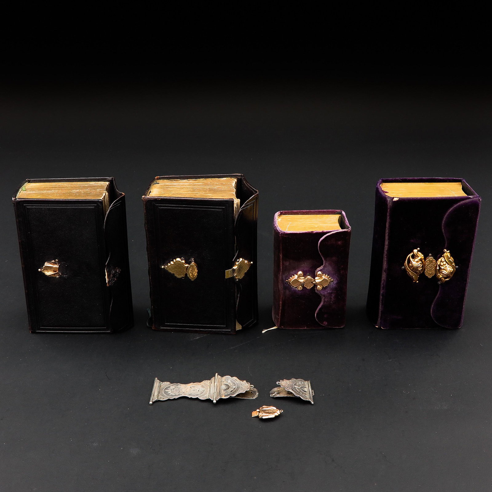 A Lot of 4 Bibles: With gold and silver clasps.
