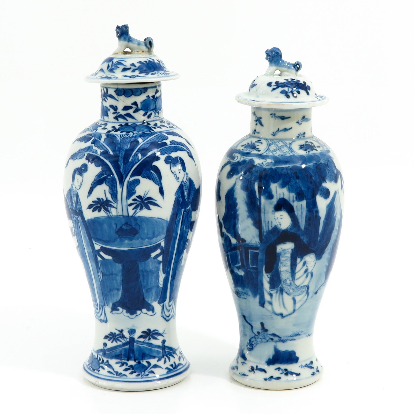 A Lot of 2 Garniture Vases: Decorated with Chinese figures, both marked Kangxi, tallest vase is 29 cm., in diverse conditions.