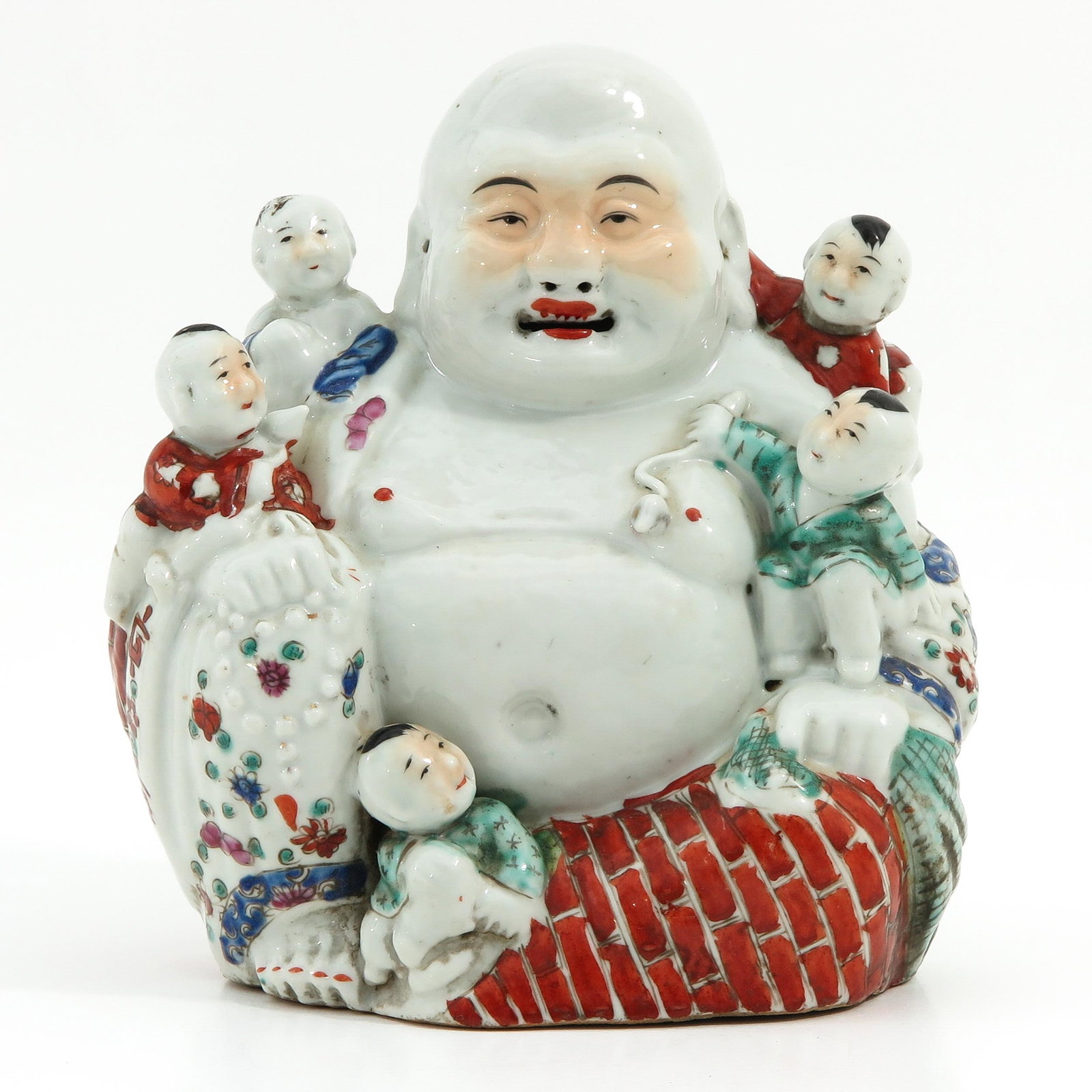 A Buddha Sculpture: Depicting Buddha holding children, 21 cm. tall.