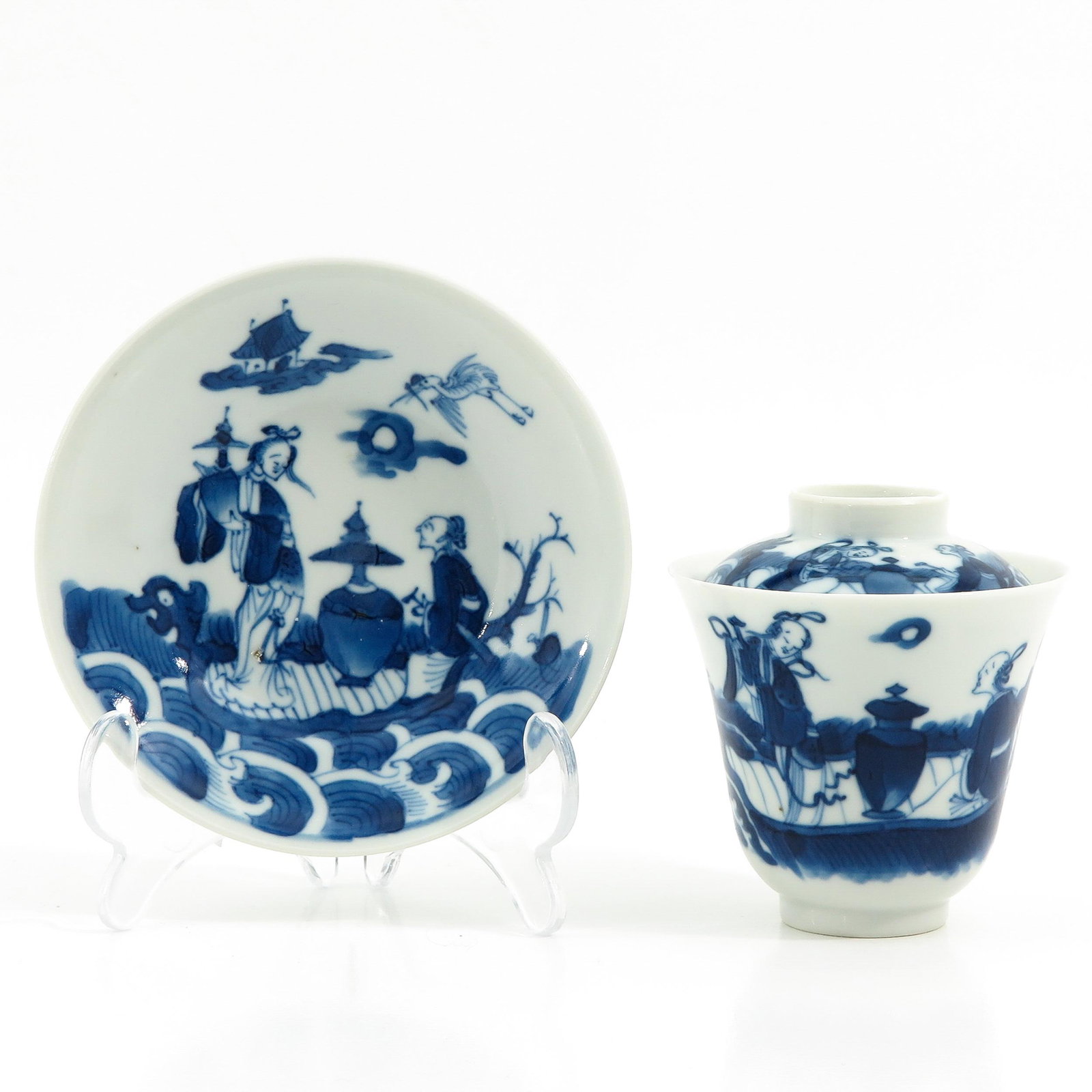 A Cup and Saucer with Cover: Decorated with Chinese figures with antiquities, saucer is 12 cm. in diameter, chip.