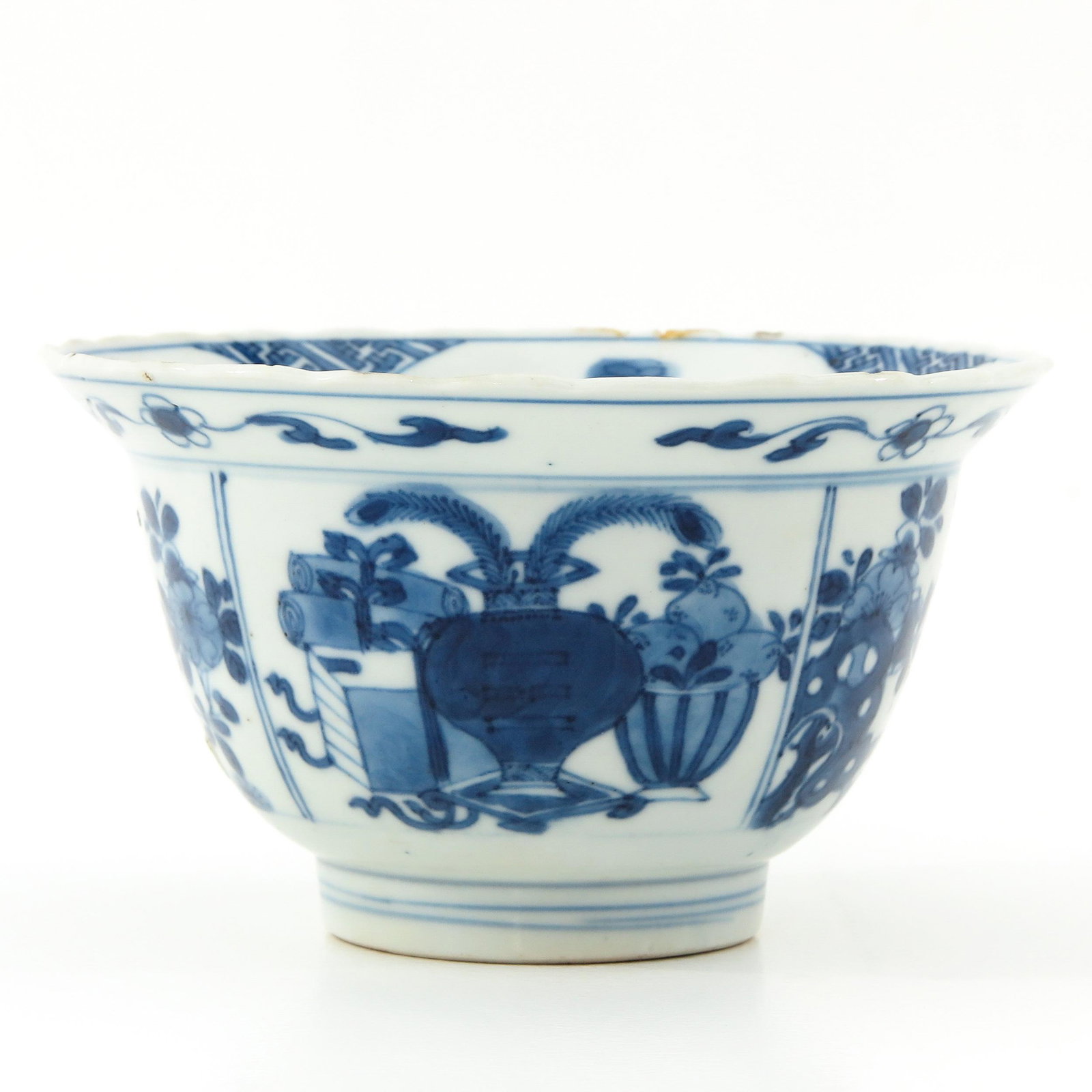 A Blue and White Bowl: Floral decor, 18th Century, marked with double ring and Artemisia leaf, 12 cm. in diameter, restoration on rim.