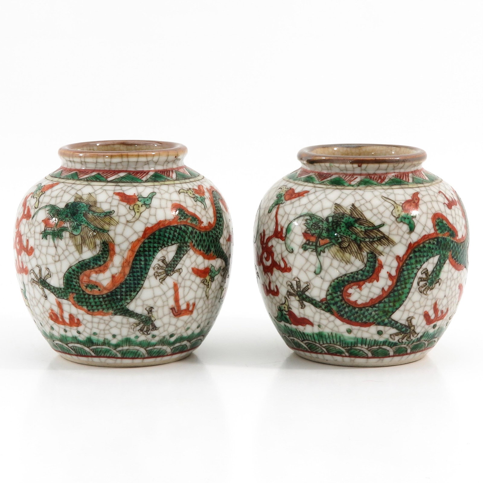 A Pair of Famille Verte Jars: Crackle ground decorated with dragons, 1 cm. tall.