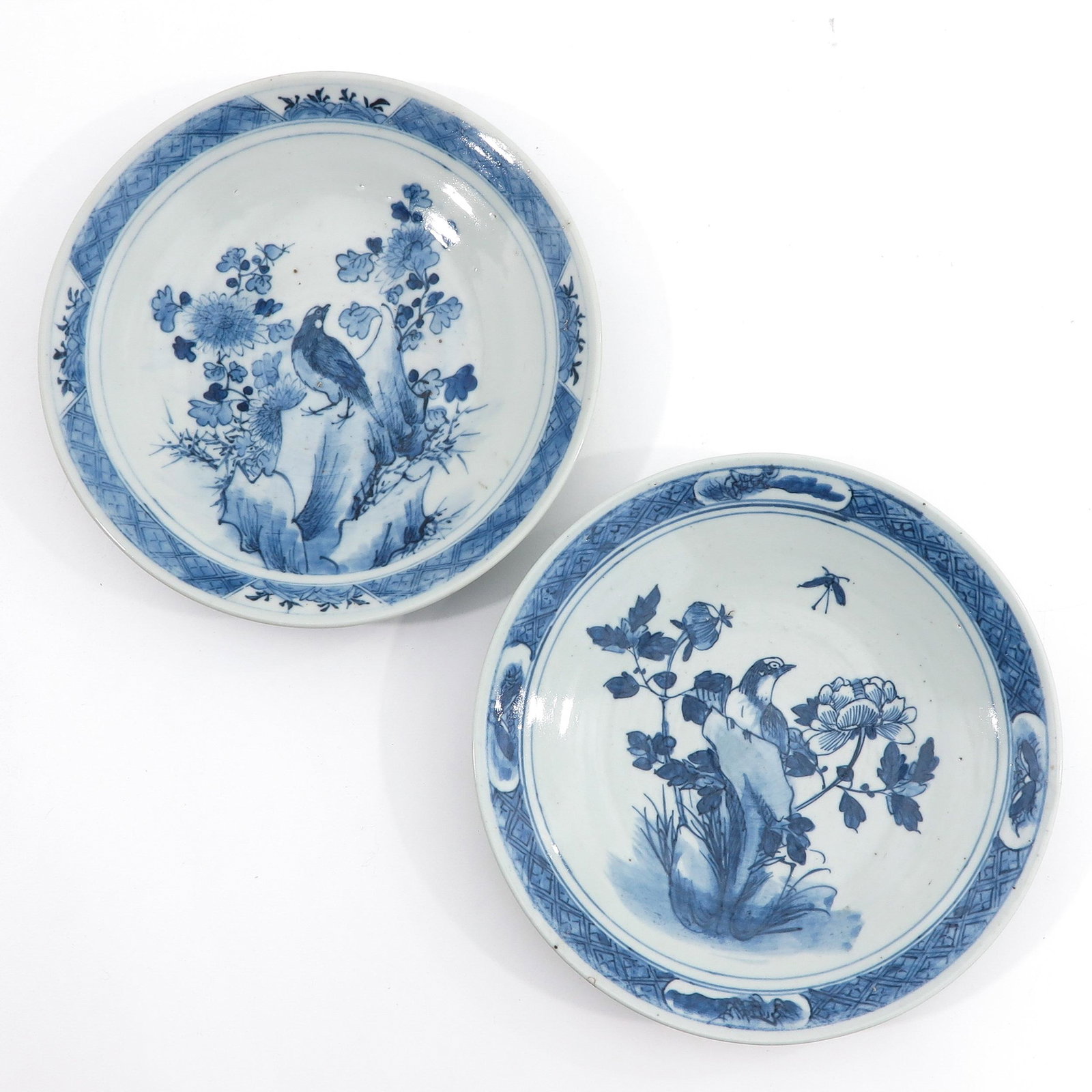 A Pair of Blue and White Chargers: Depicting birds and flowers, 27 cm. in diameter, chip.