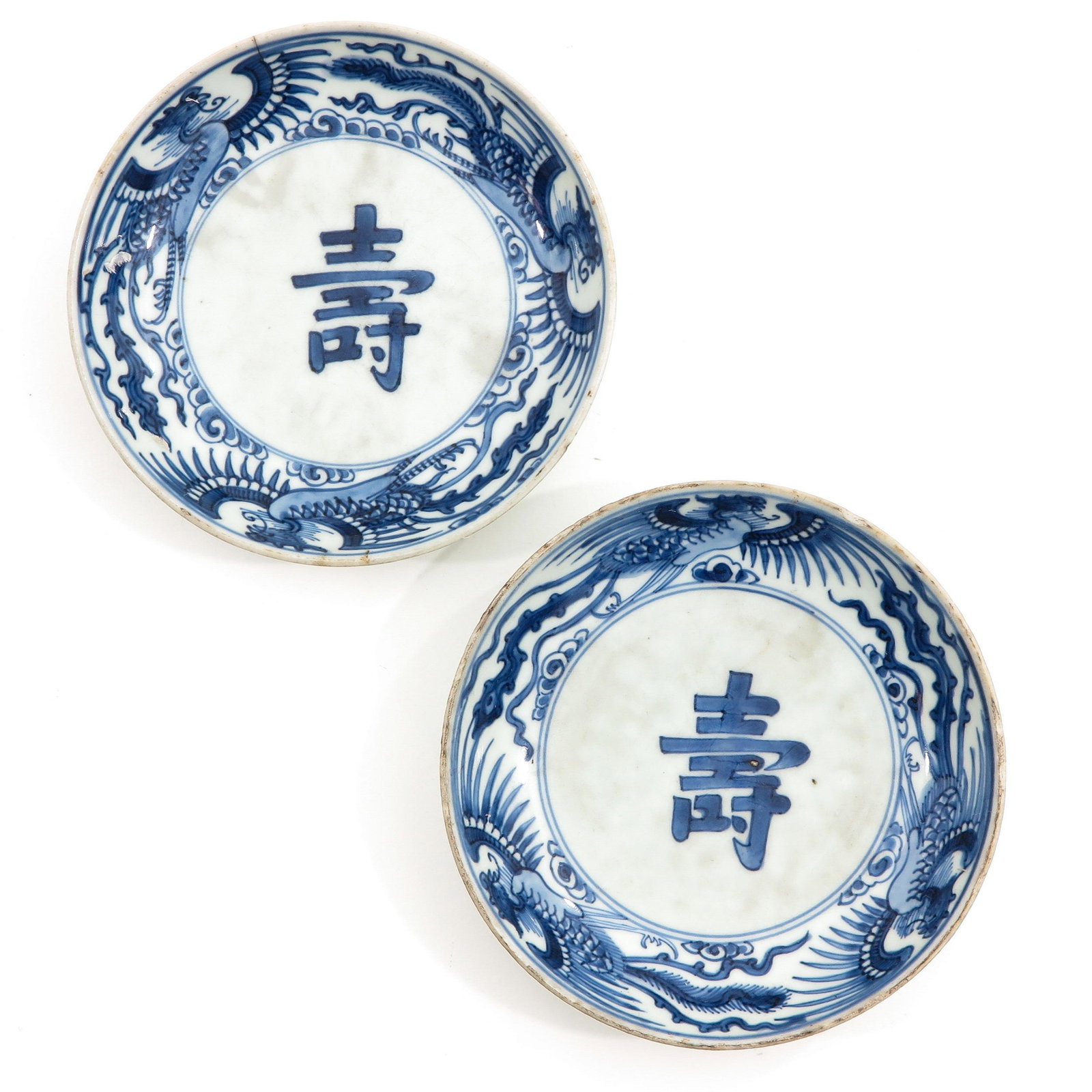A Pair of Blue and White Plates: Decorated with Chinese text and bird of paradise, marked with double ring and twin fish,16 cm. in diameter.