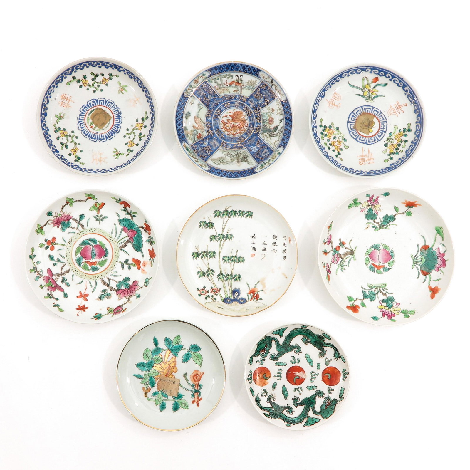 A Lot of 8 Small Plates: In diverse decors and sizes, largest plate is 17 cm. in diameter, chip and hairline.