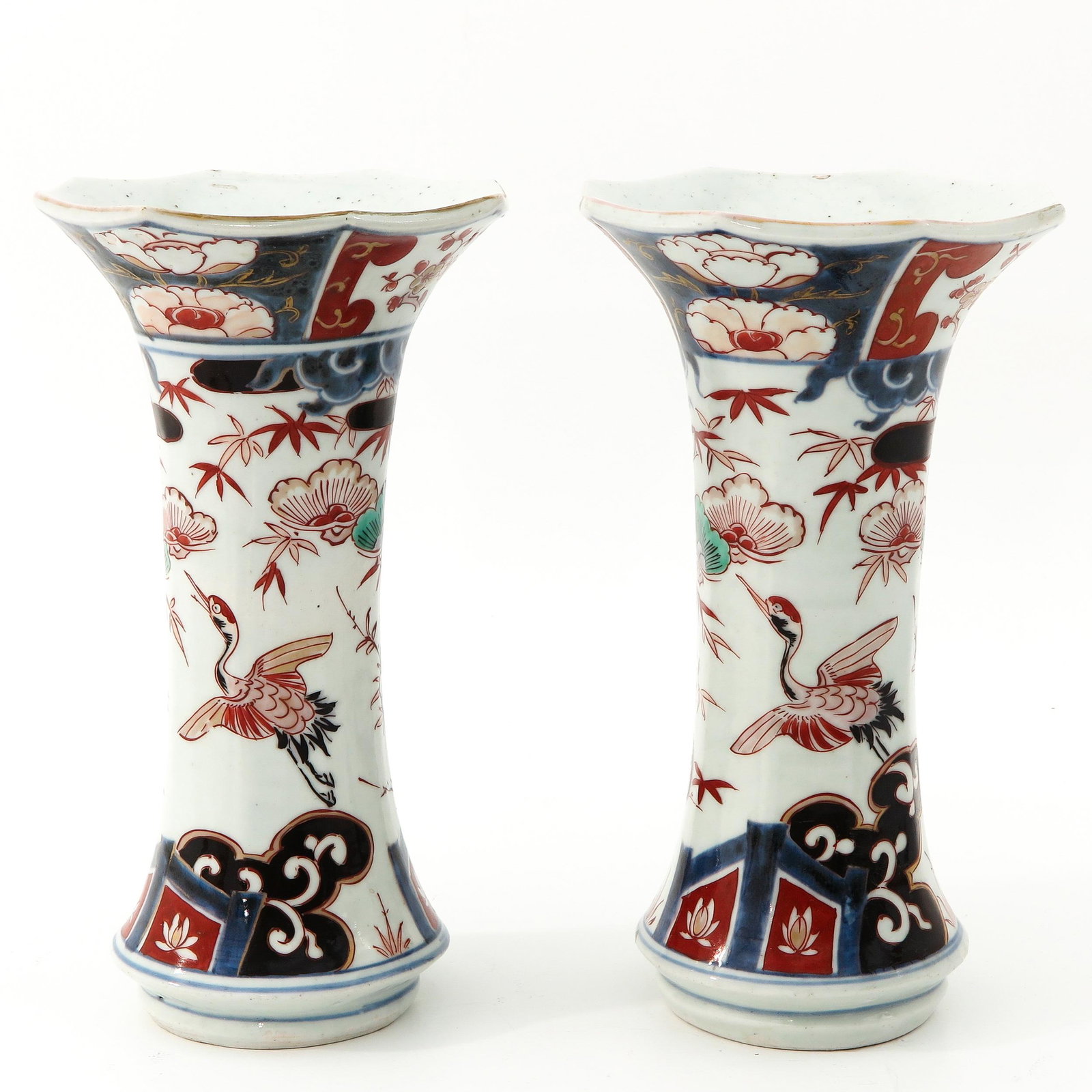 A Pair of Imari Vases: Decorated with flowers and birds, 26 cm. tall.