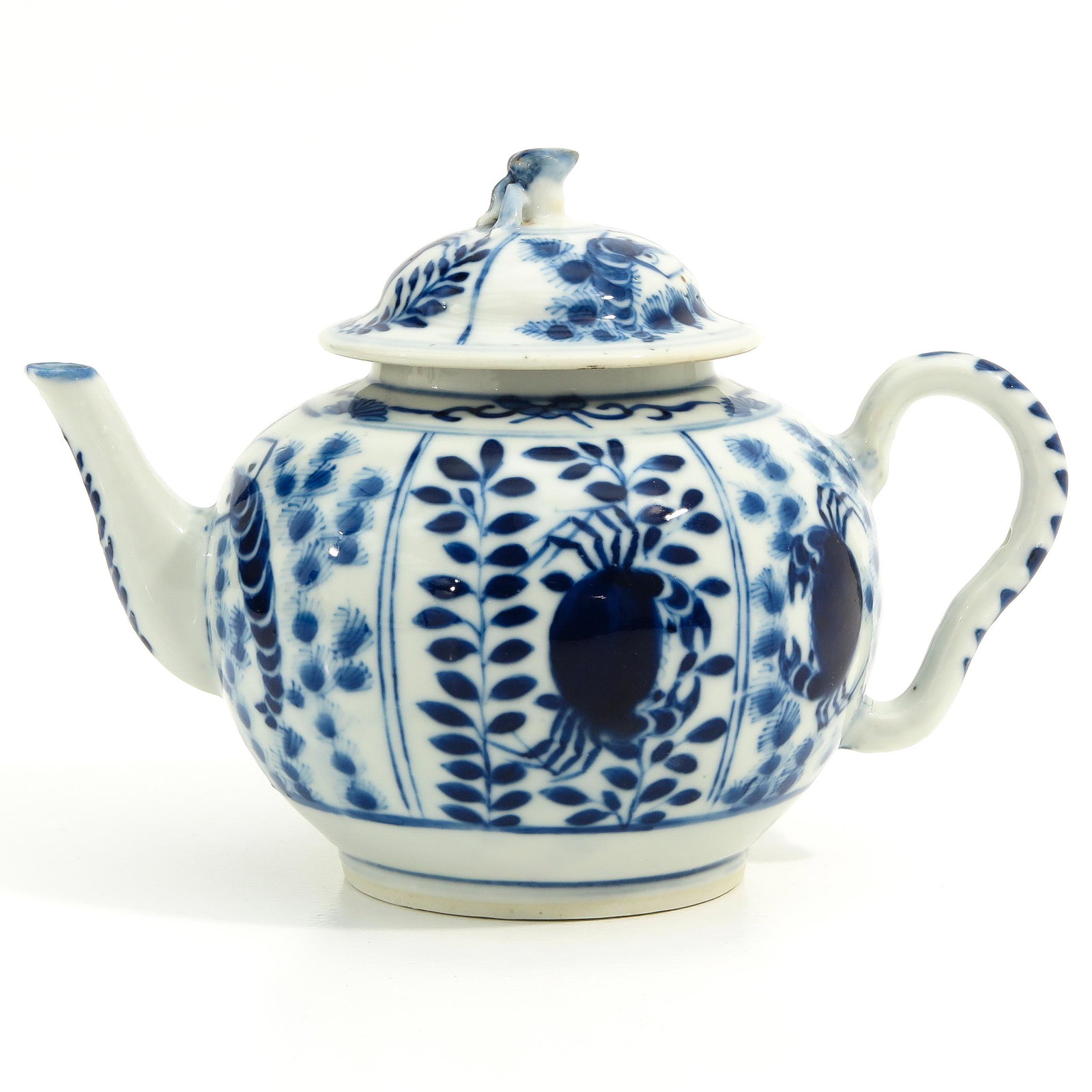 A Blue and White Teapot: Floral decor with sea creatures, 14 cm. tall, chip.
