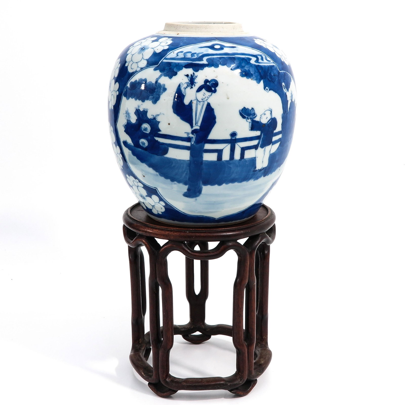A Blue and White Jar: With nicely carved wood stand, jar is decorated in floral ground with Chinese lady and boy in garden and is 21 cm. tall, stand is 20 cm. tall.