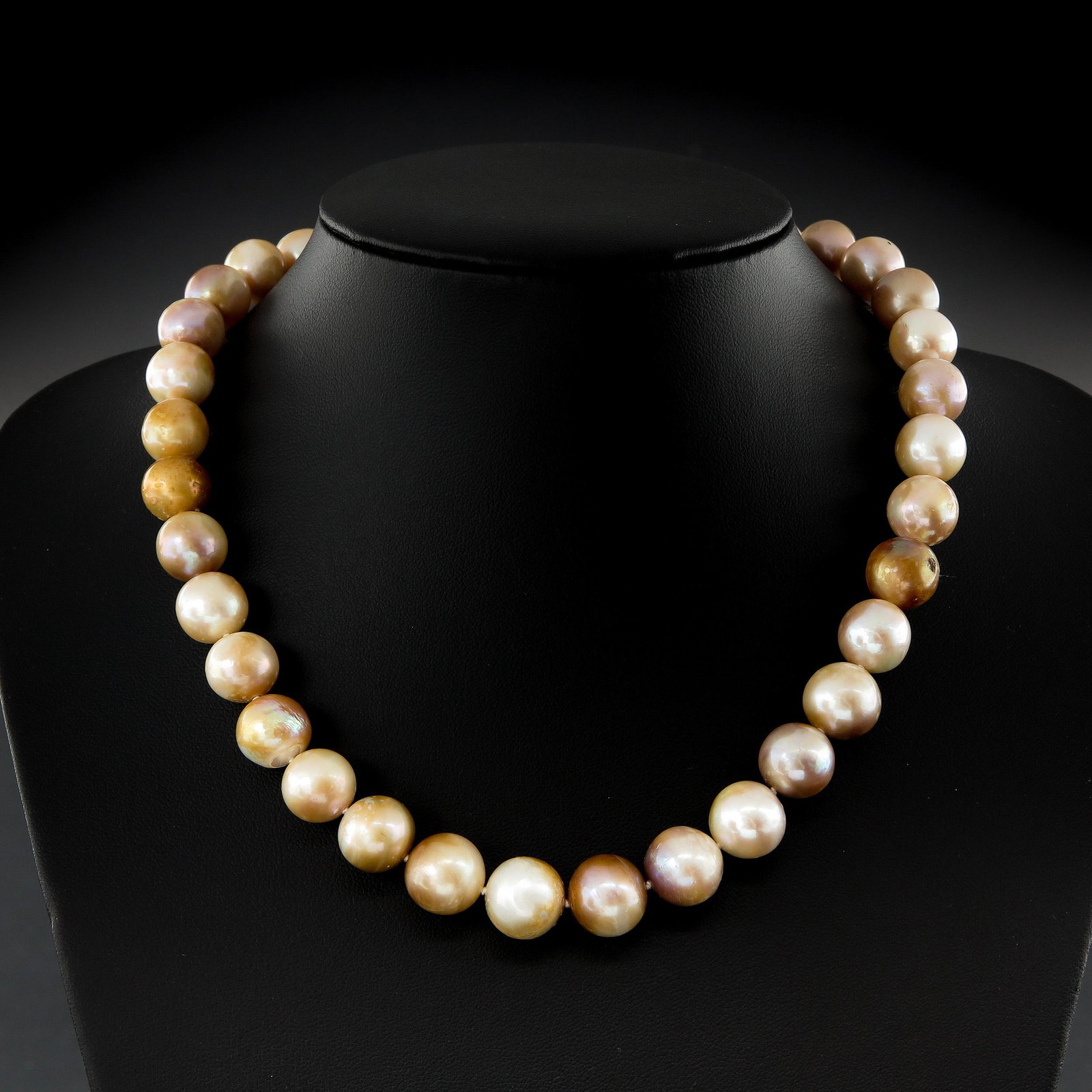 A Ladies Pearl Necklace: Diameter 11 - 13 mm., and 14KG Clasp.