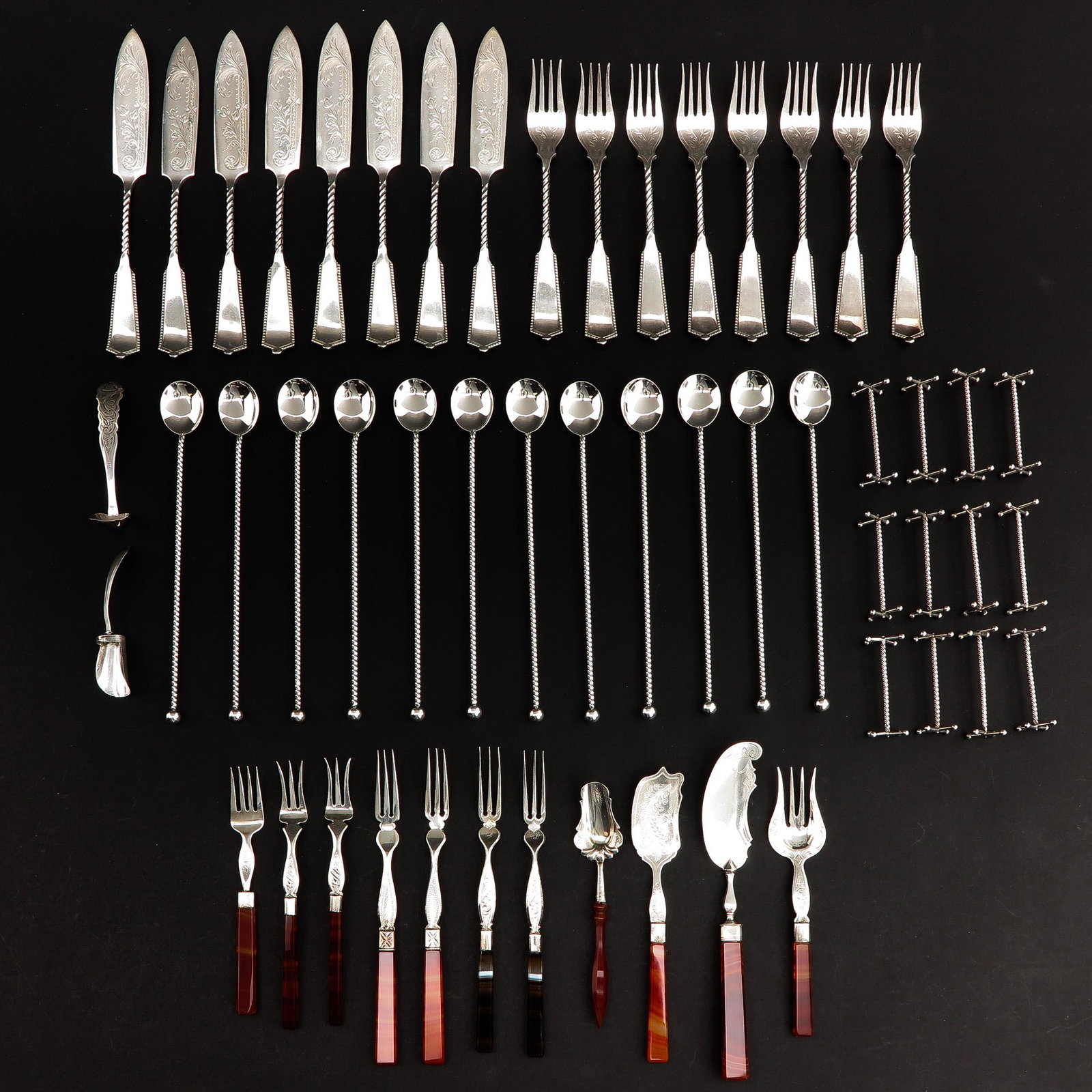 A Diverse Collection of Silver Cutlery: Consisting of silver cutlery parts, including trimmed with Carnolian.