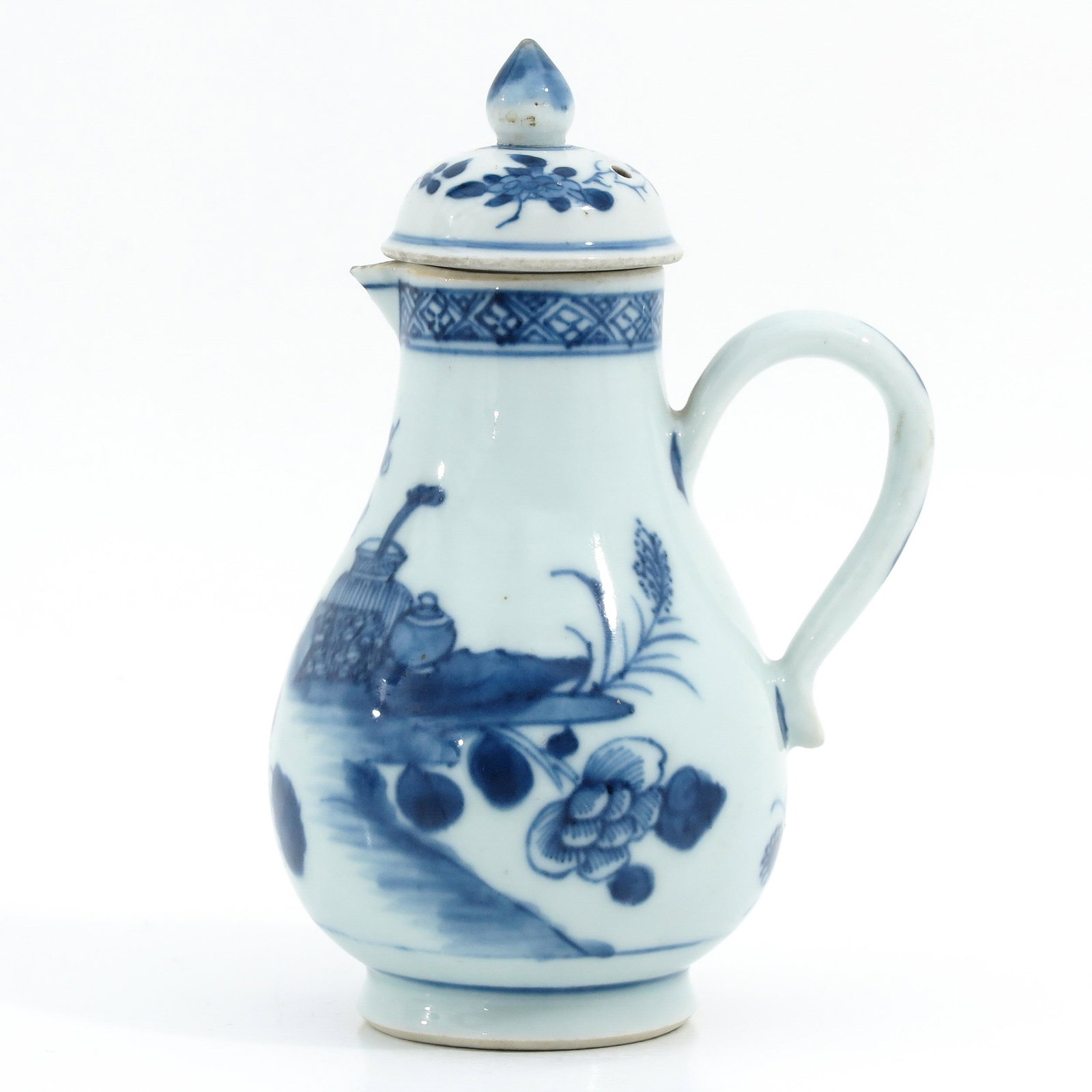 A Blue and White Creamer with Cover: Decorated with flowers and Chinese antiquities, 16 cm. tall.