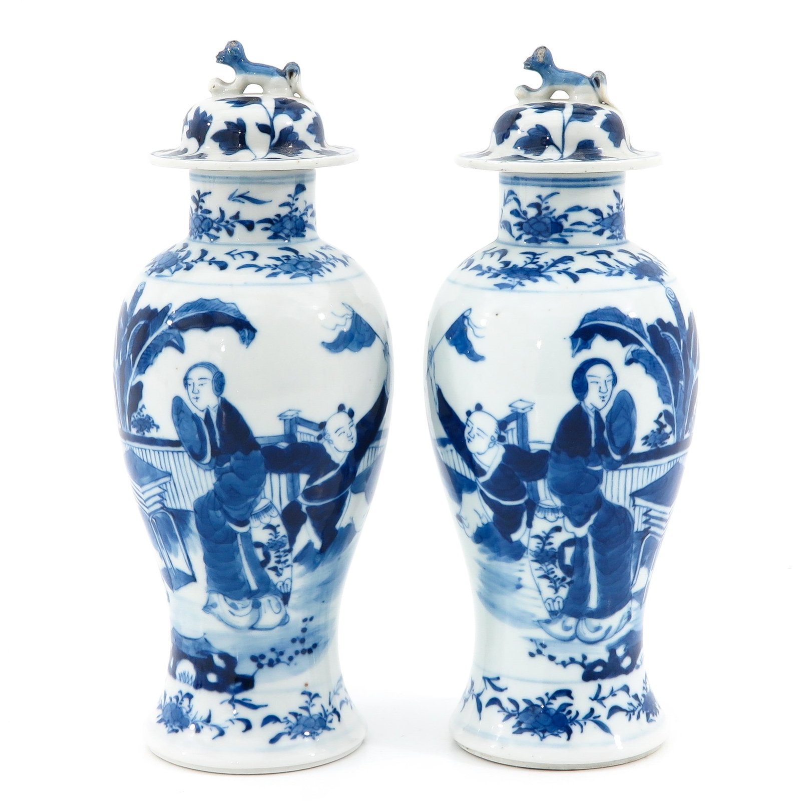 A Pair of Blue and White Vases: Depicting Chinese figures, Kangxi mark, 27 cm. tall.