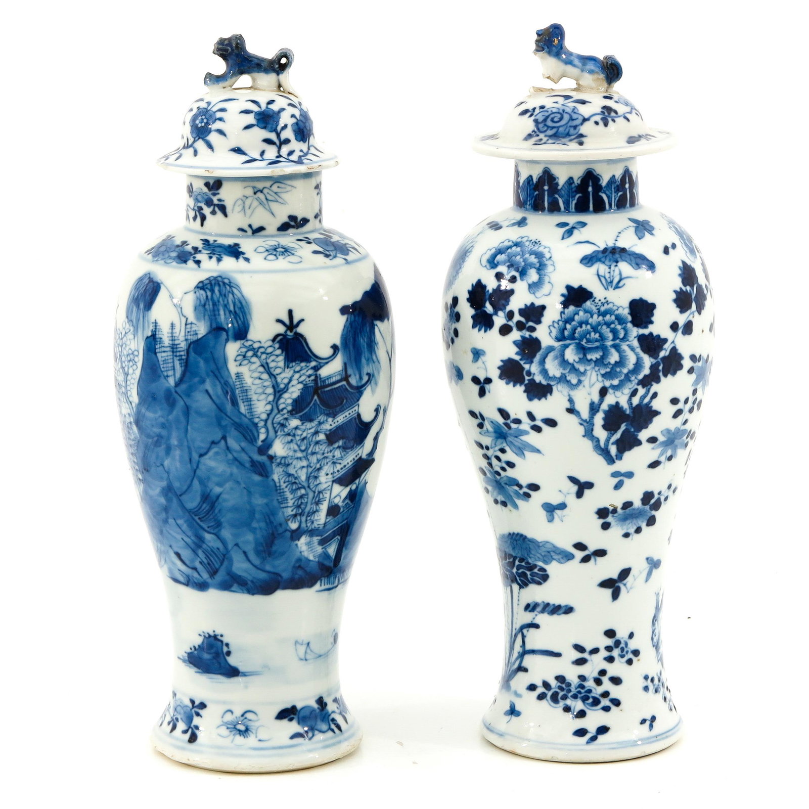 A Lot of 2 Garniture Vases: Blue and white floral and landscape decors, 27 cm. tall, restoration on cover.