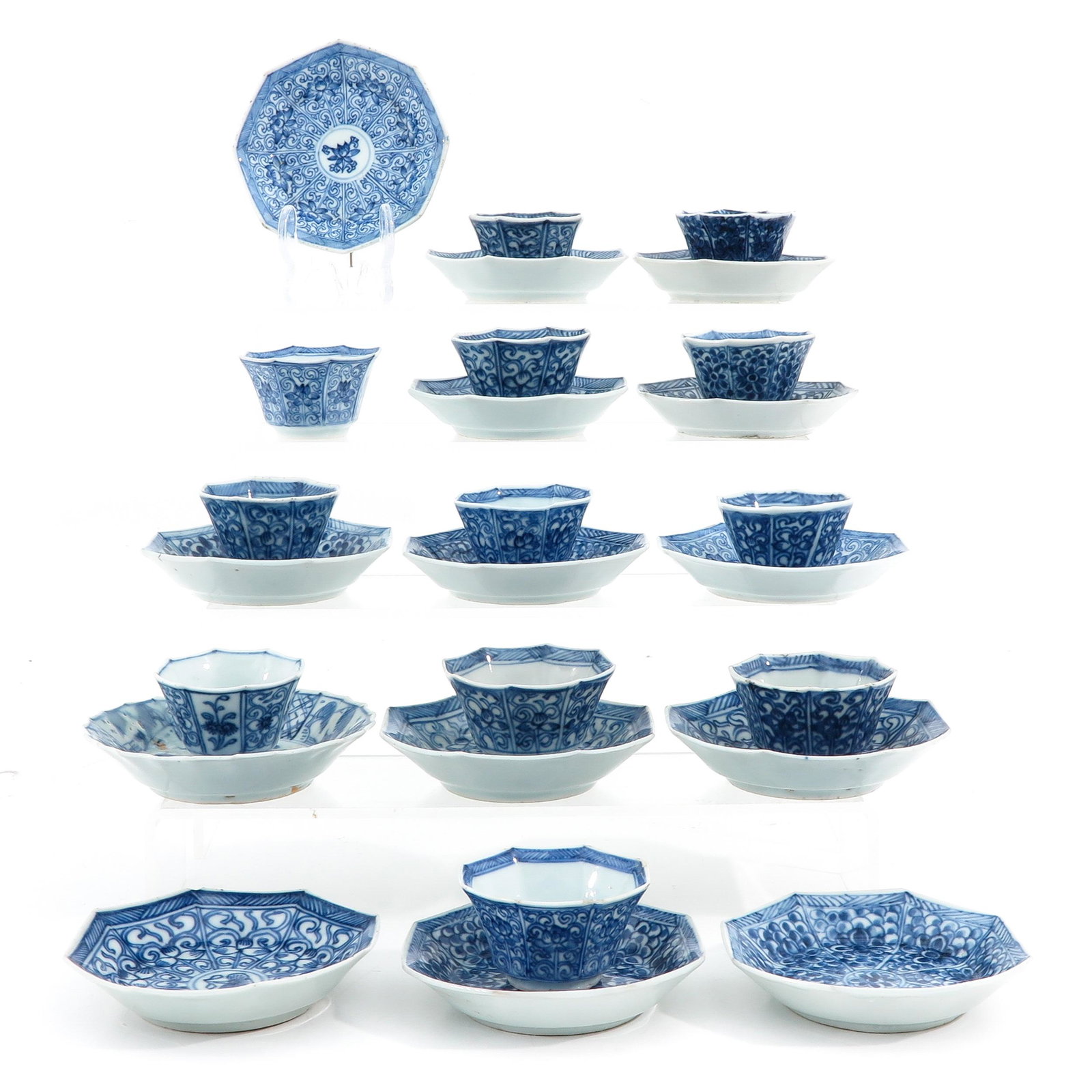 A Collection of Cups and Saucers: Including 12 cups and 14 saucers, in blue and white decors, largest saucer is 10 cm. in diameter.
