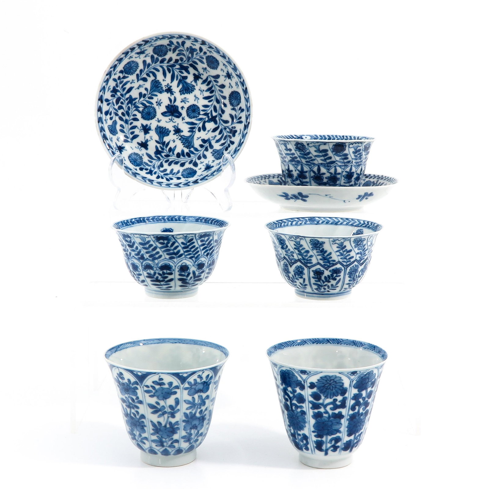 A Collection of Cups and Saucers: Including 5 cups and 2 saucers, blue and white floral decors, saucers are 13 cm. in diameter.