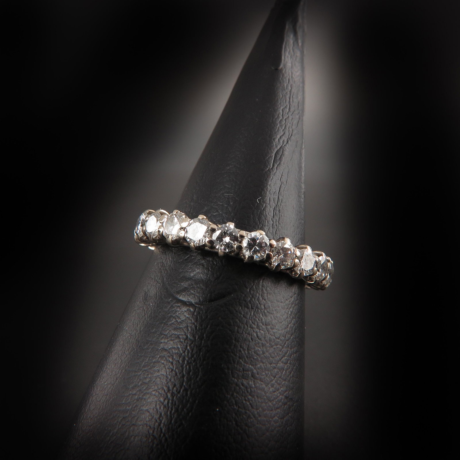 A Diamond Eternity Band: Diamonds are approximately 3 mm. in diameter, ring size 17.
