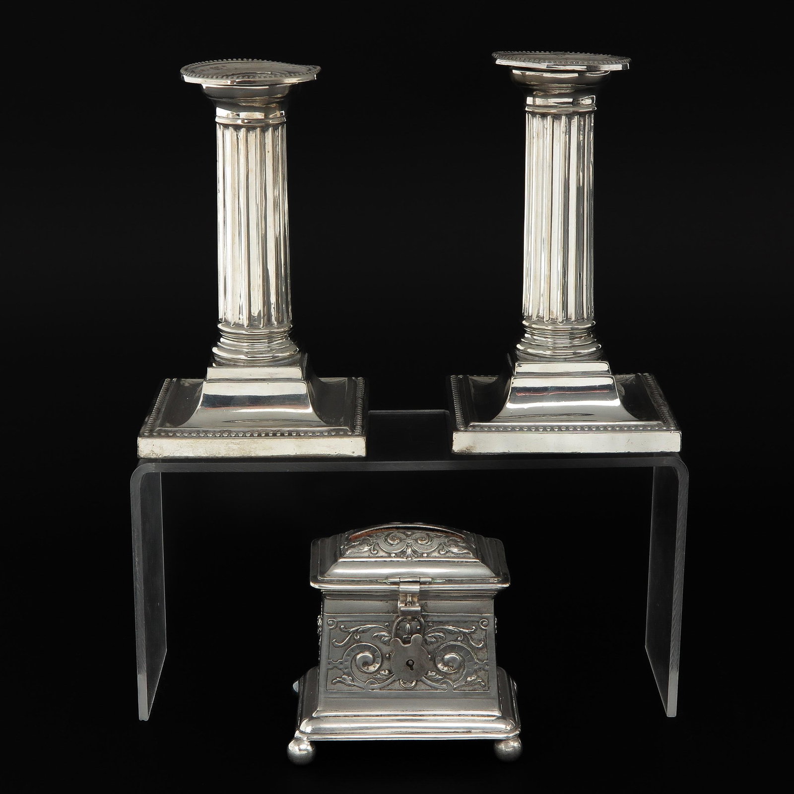 A Silver Savings Pot and Pair of Candlesticks: England, 1st degree silver, marked J.D & S, 13 cm. tall.