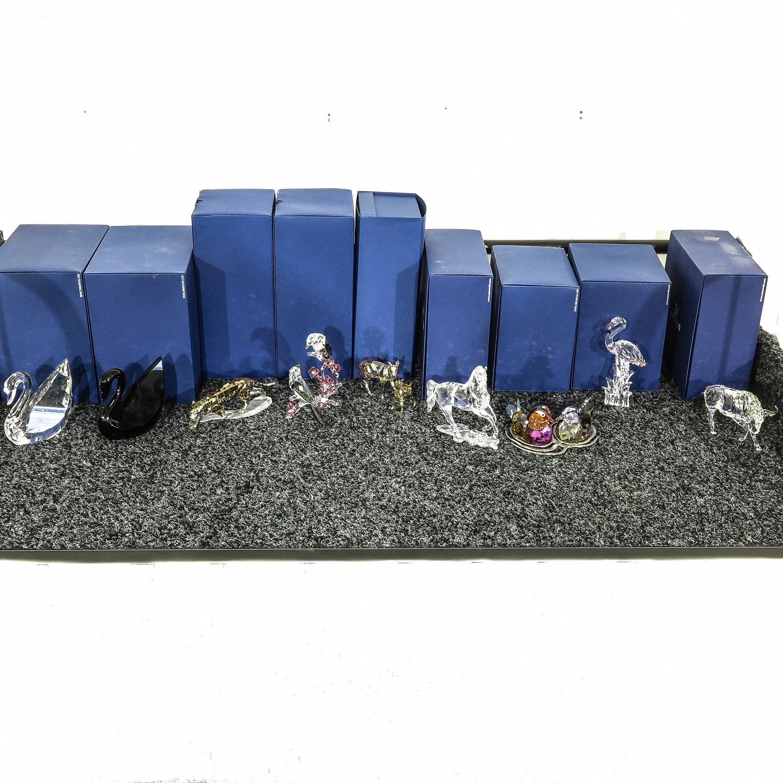 A Collection of Nine Swarovski Crystal Sculptures: Including black swan, with boxes, 12 cm. tall.