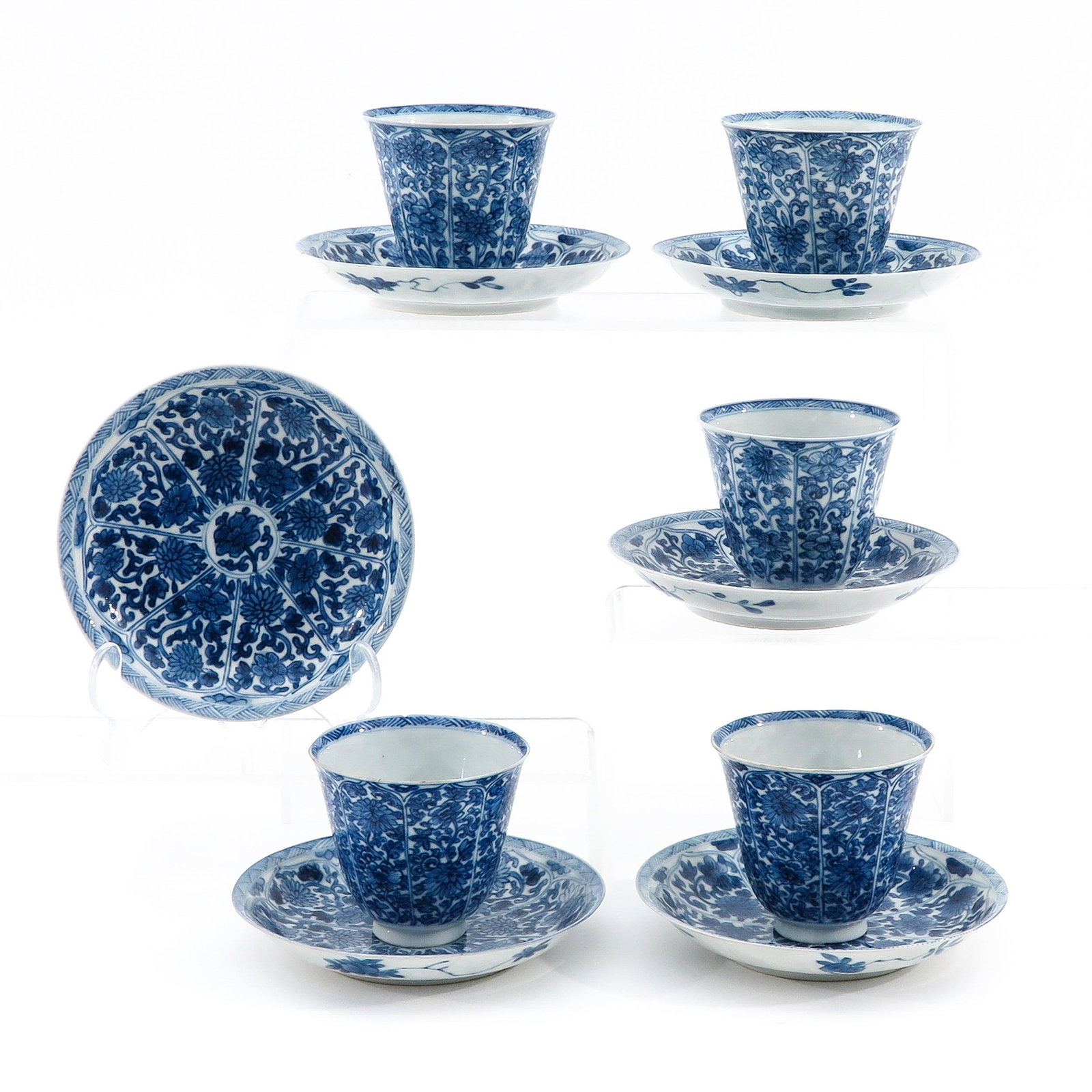 A Collection of Blue and White Cups and Saucers: Including 5 cups and 6 saucers, floral decor, 18th Century, saucers are 13 cm. in diameter, chip and hairline.