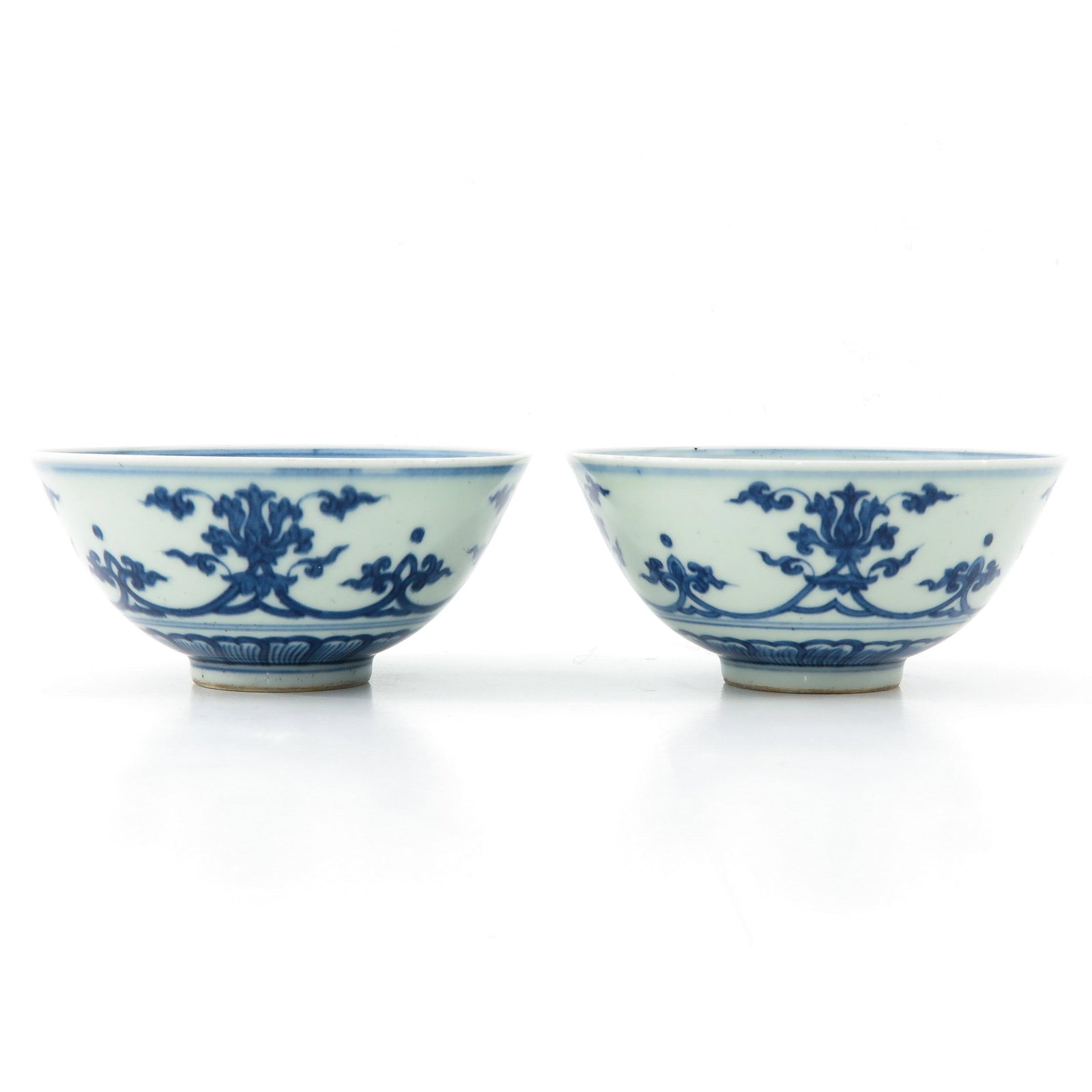 A Pair of Blue and White Bowls: Floral decor, Chenghua mark, 15 cm. in diameter.