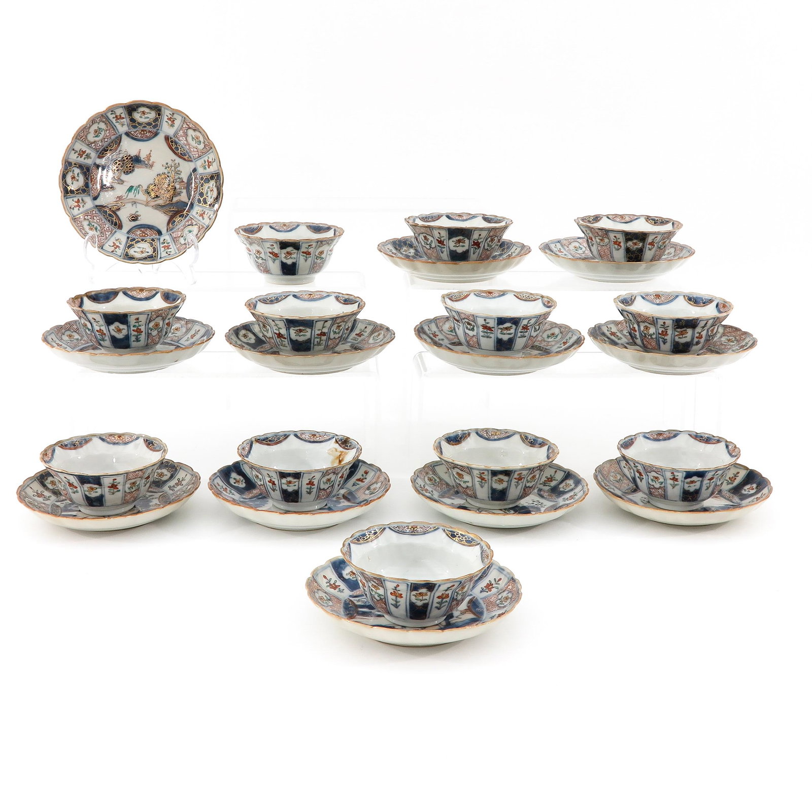 A Series of 12 Cups and Saucers: Landscape and floral decor, saucers are 14 cm. in diameter, hairline.
