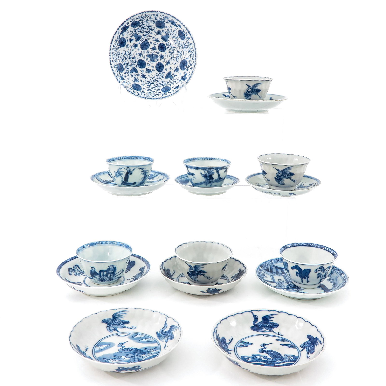 A Collection of Cups and Saucers: Including 7 cups and 10 saucers, in a variety of blue and white decors, largest saucer is 12 cm. in diameter, chip and hairline.
