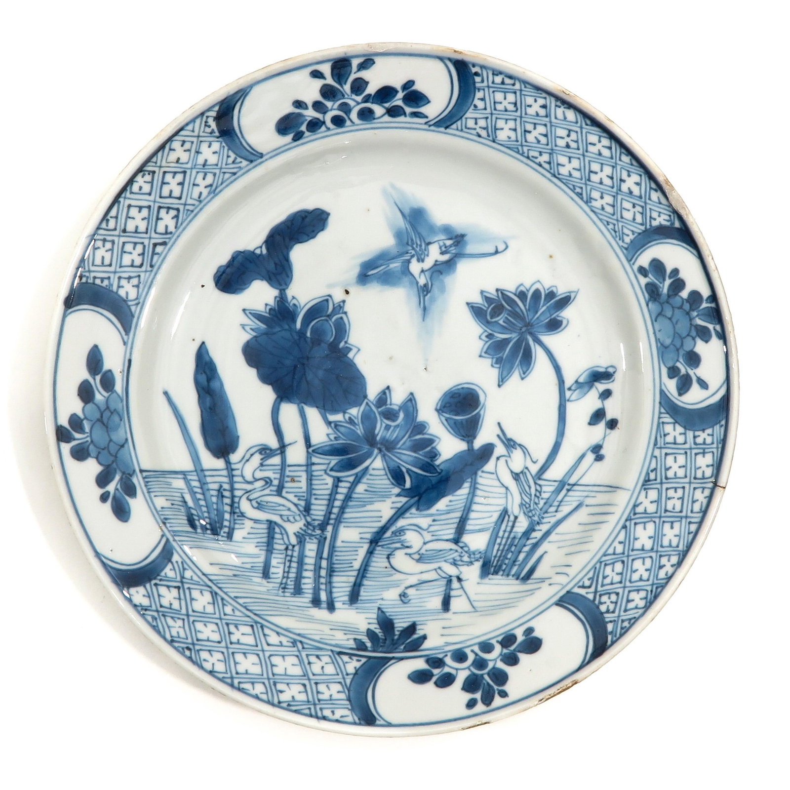 A Blue and White Plate: Depicting scene on pond with water lillies and birds, 22 cm. in diameter.
