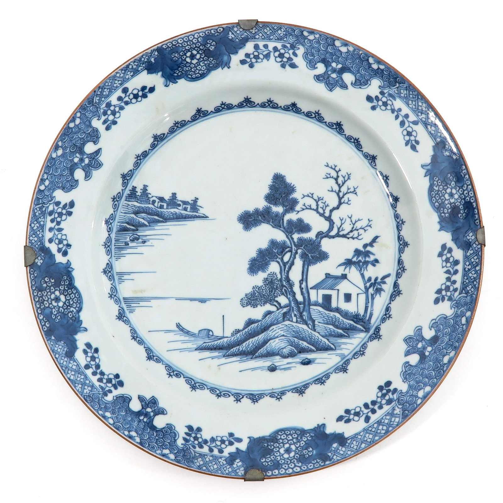 A Blue and White Charger: Landscape decor with floral border, 31 cm. in diameter.